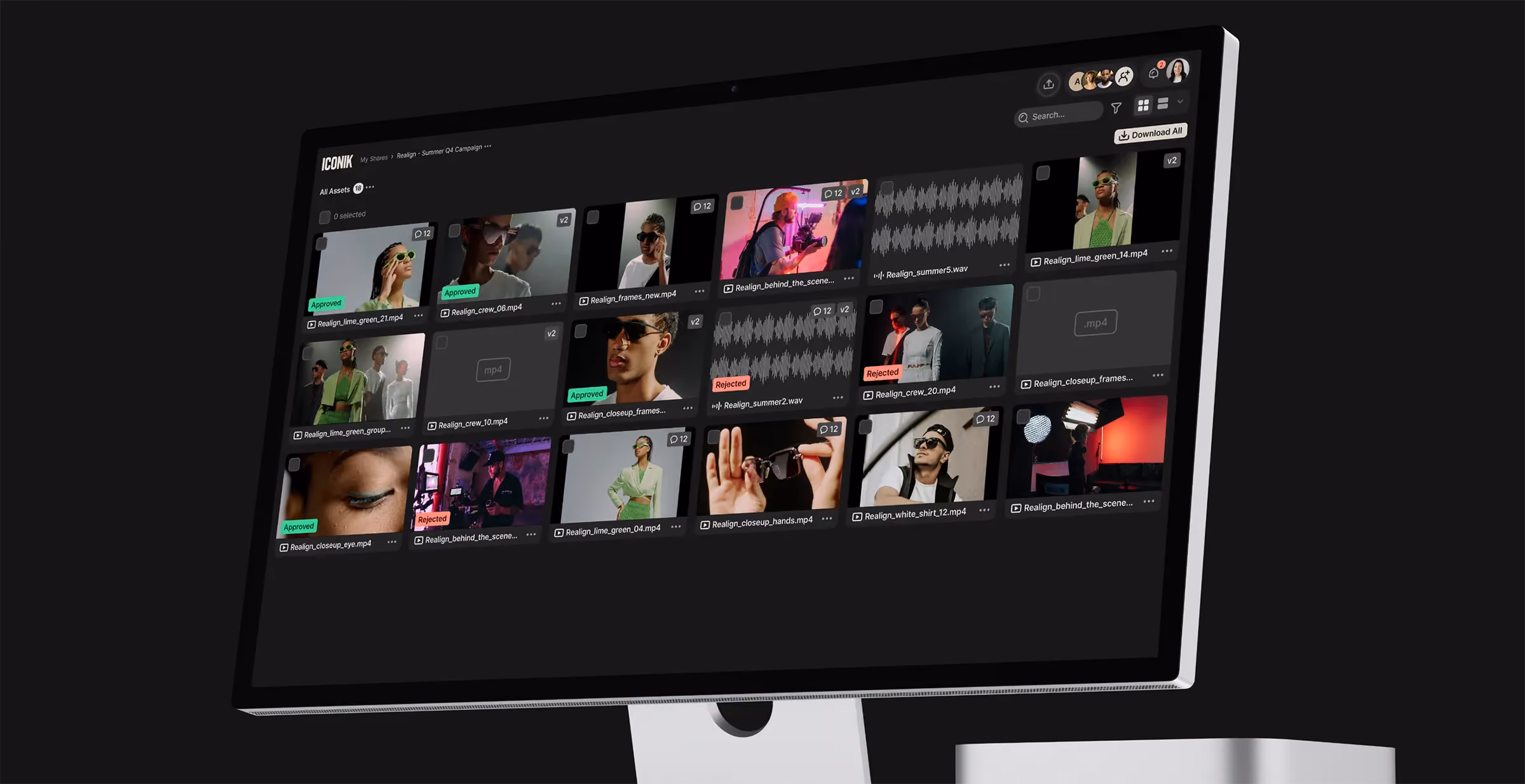 Computer monitor displaying a grid of video assets with approval status tags and waveforms in a media management interface.