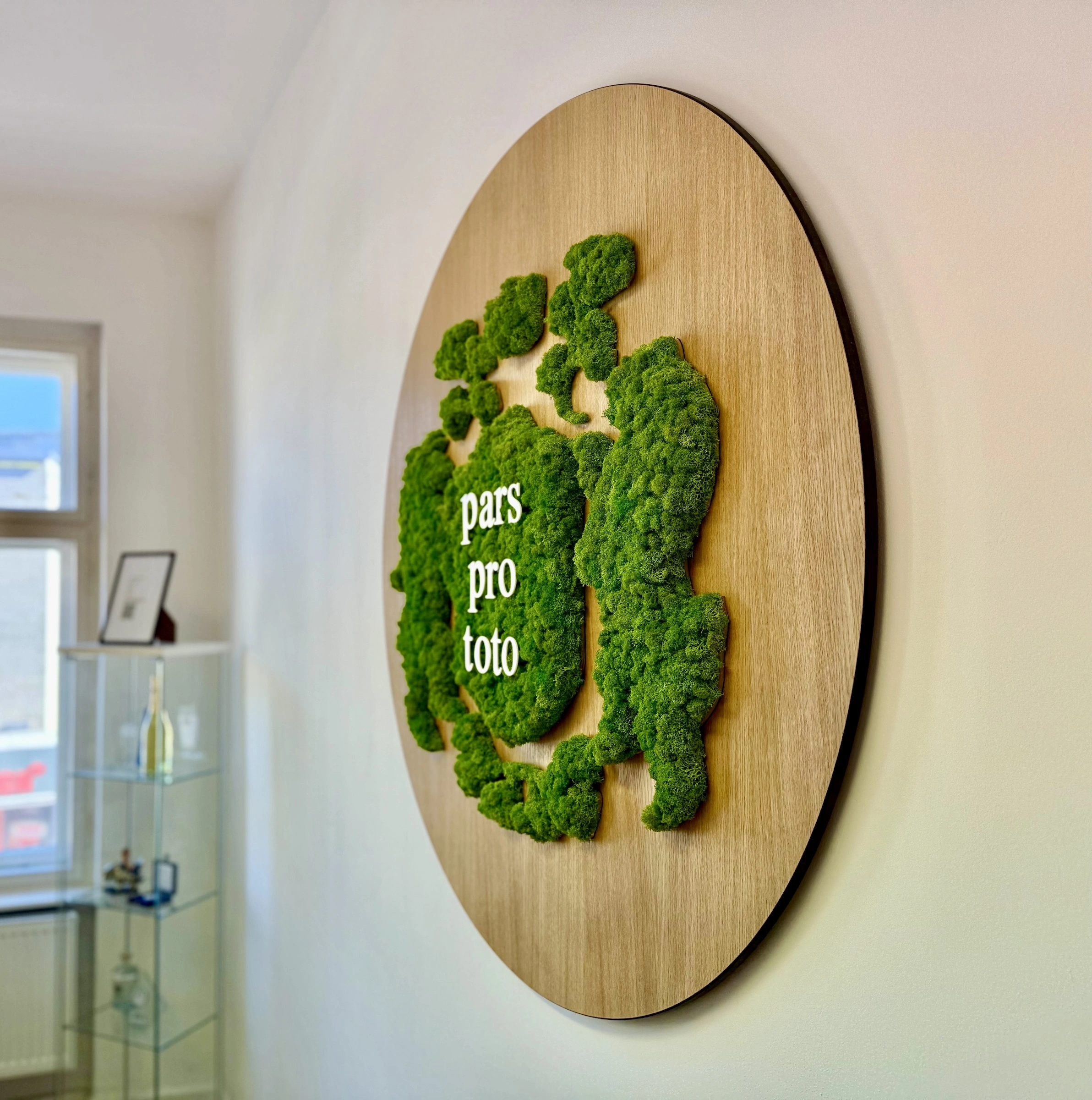 Tecis Logo made of islandmoss on a panel with real oak veneer