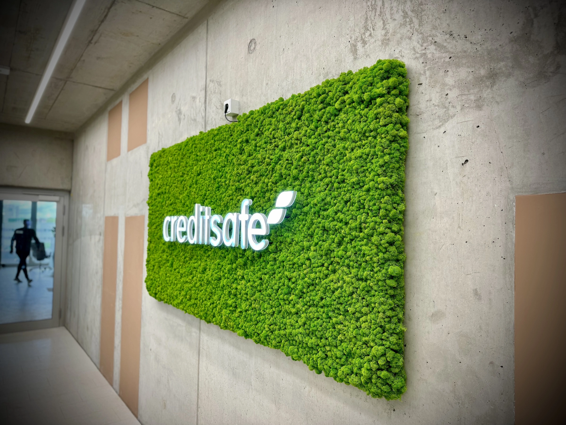 Islandmoss and Illuminated CreditSafe logo in the Entrance Area