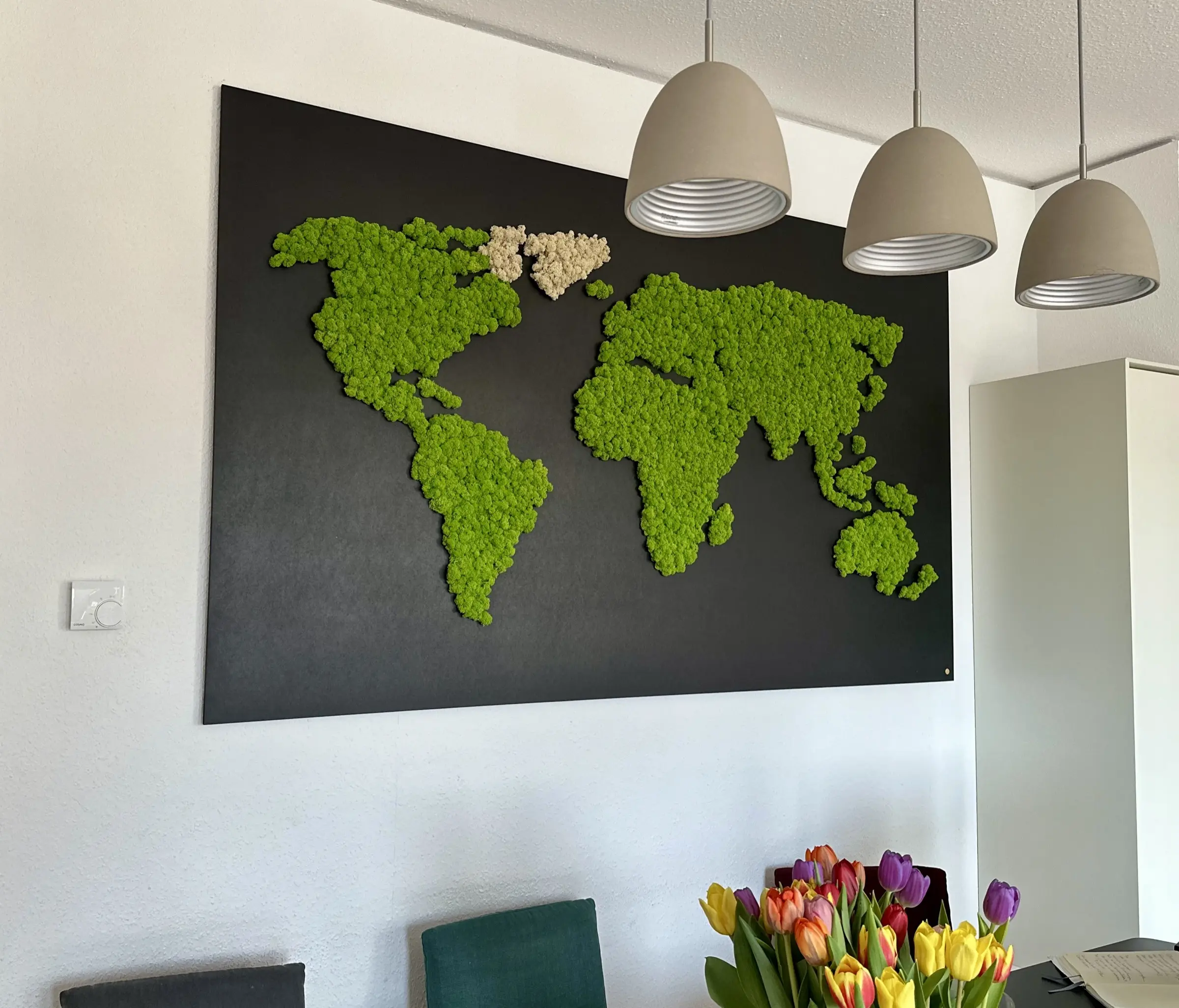 Bespoke world map from preserved green and white islandmoss on a black CNC-milled panel