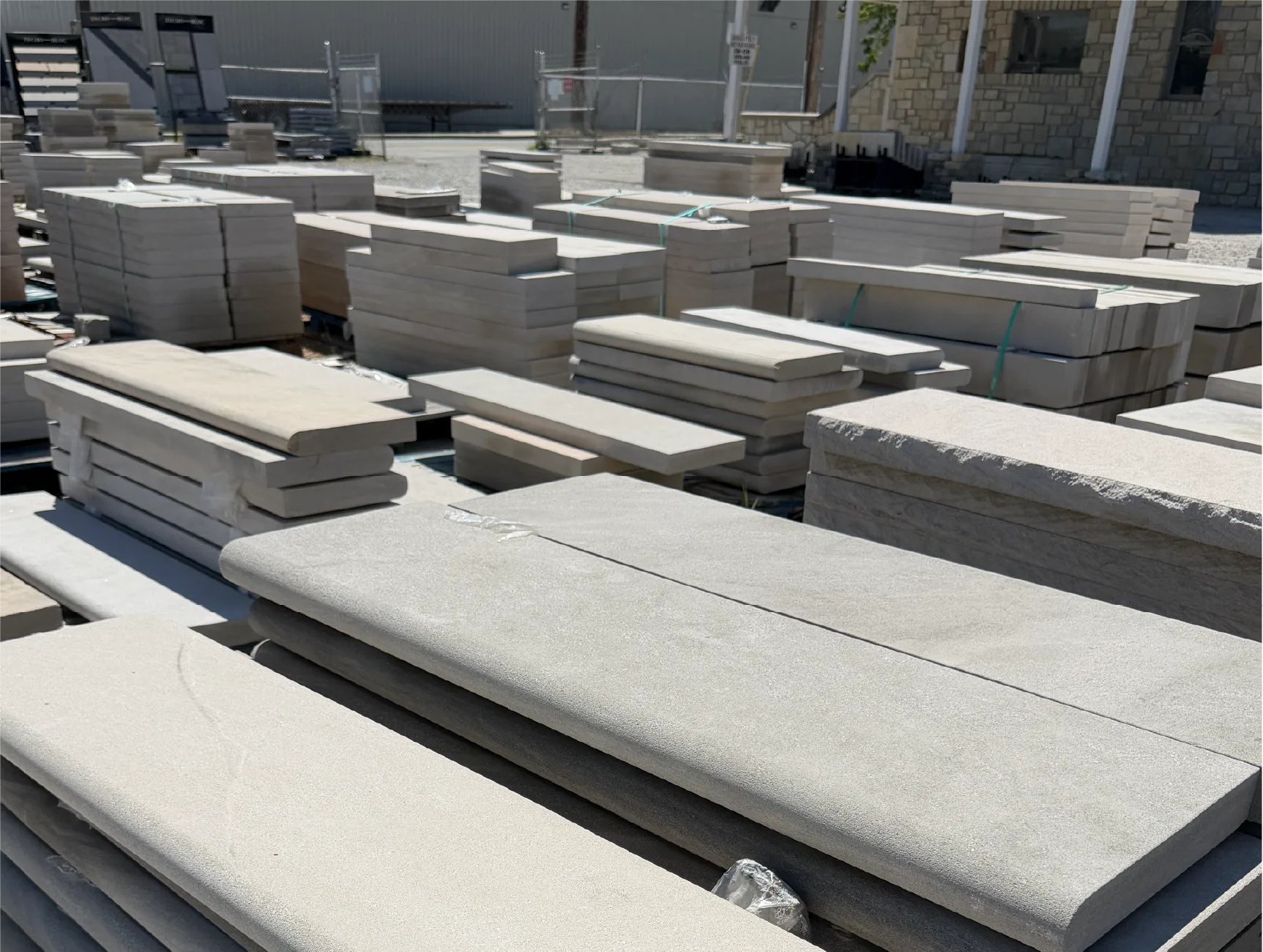 Stacks of custom-cut limestone slabs and coping at Stone Center’s Ohio fabrication yard