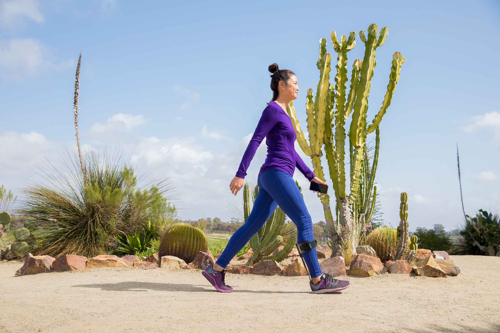 Woman walking in desert, wearing Elevate product.