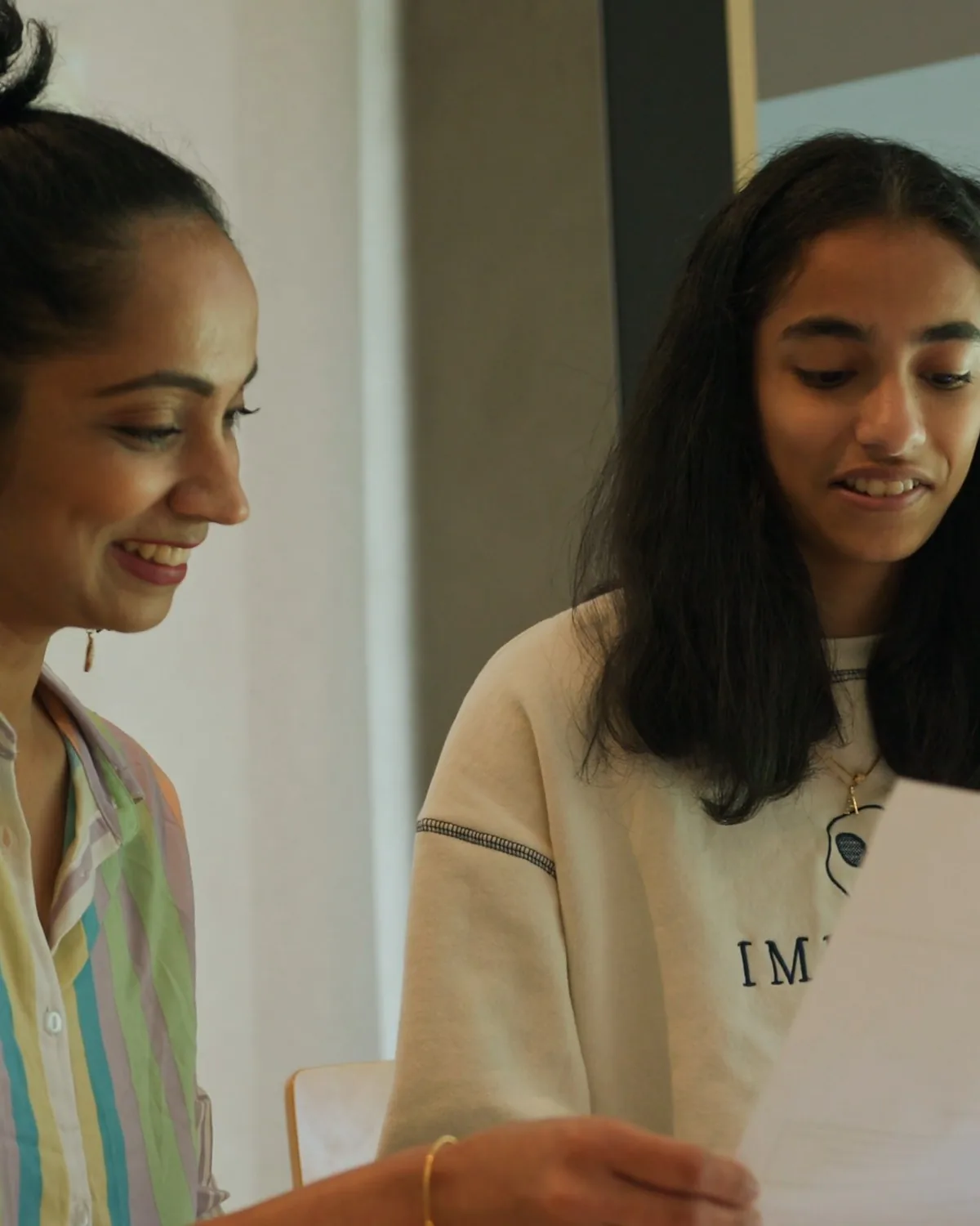 Amrita and her mum reading her marked maths test together