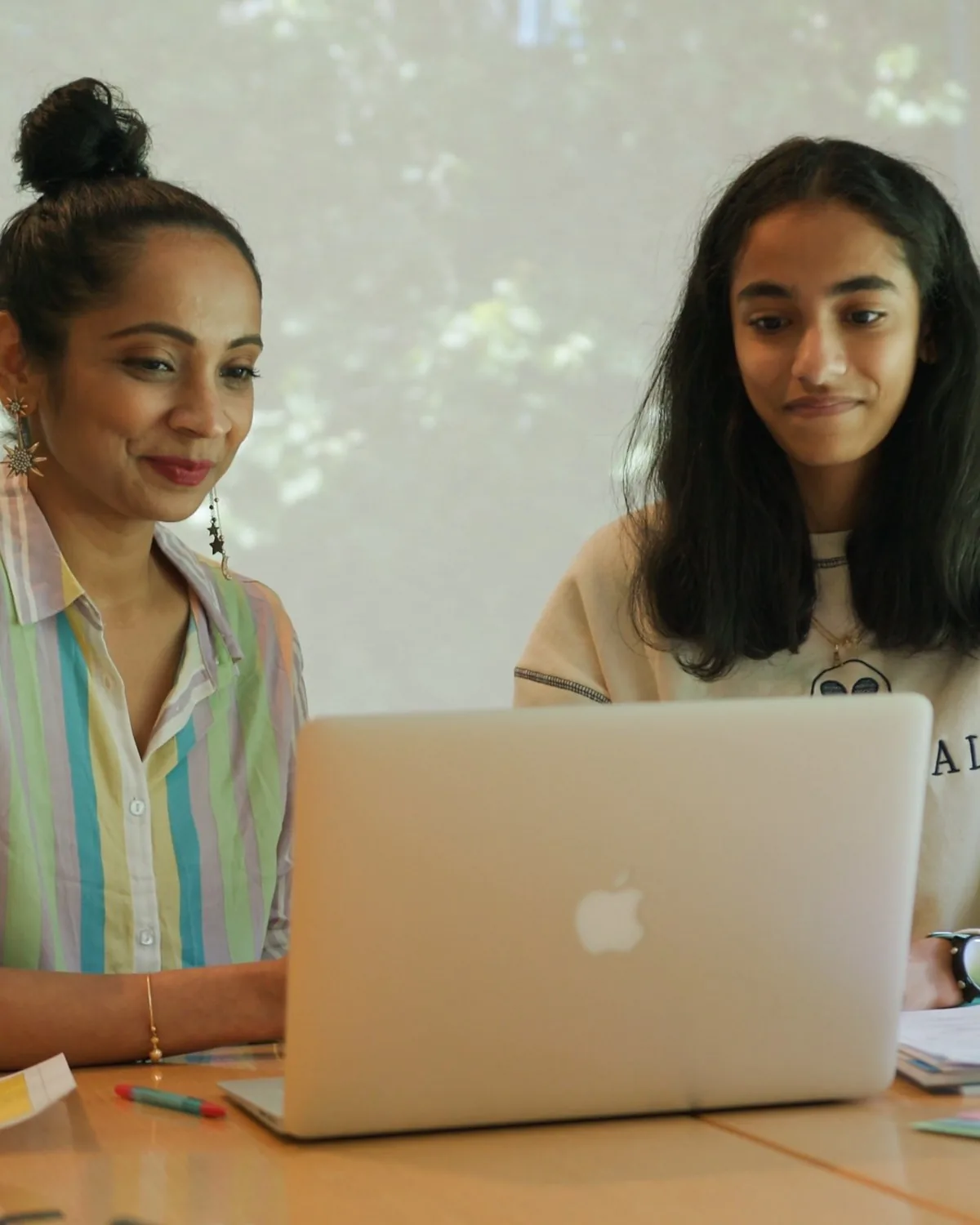Amrita and her mum at the laptop during an online maths lesson