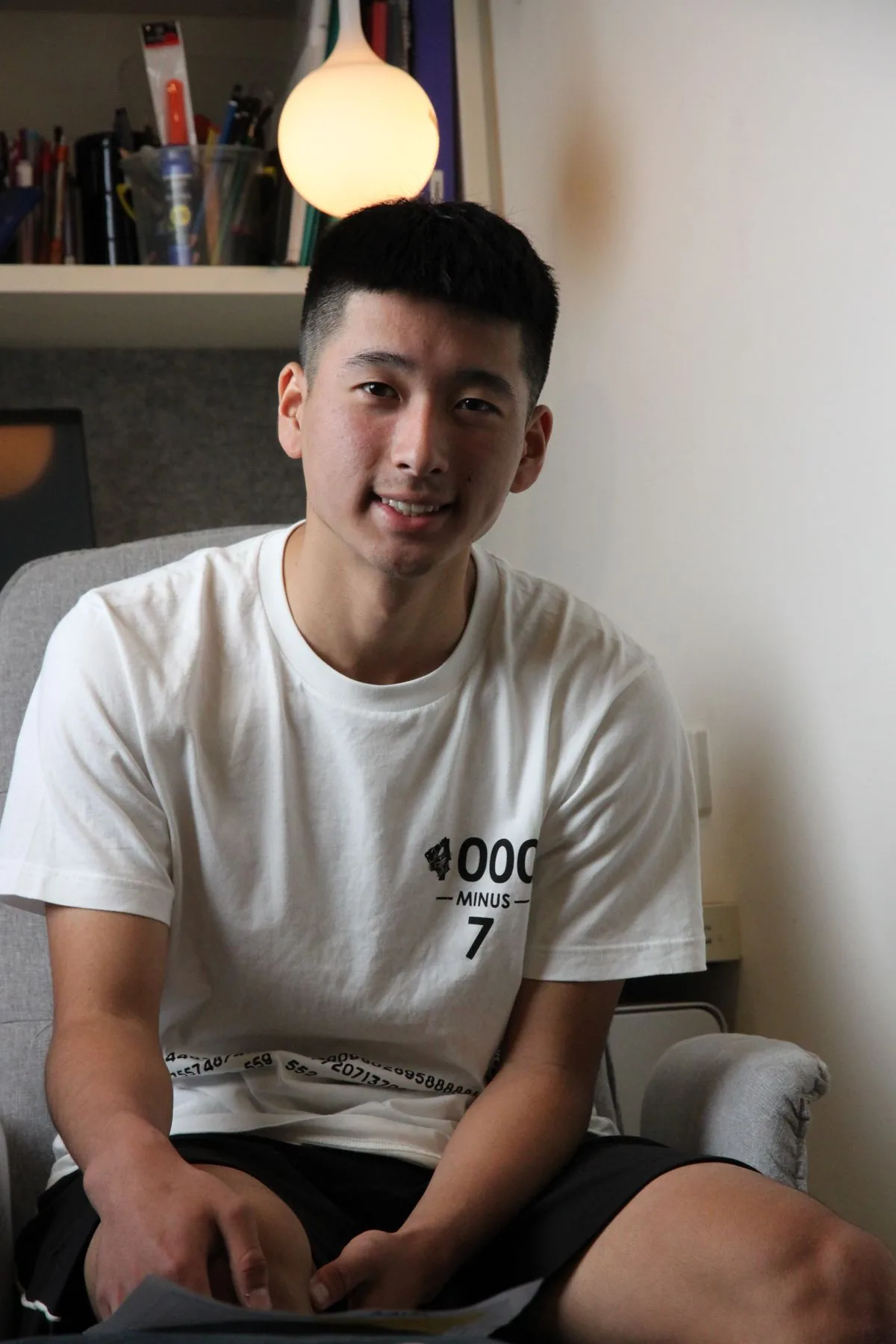 Senior student smiling at his desk at home