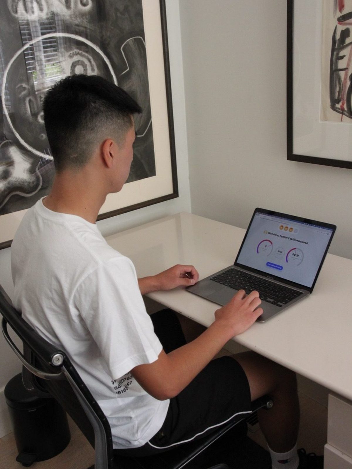 Student working through an online lesson at his desk