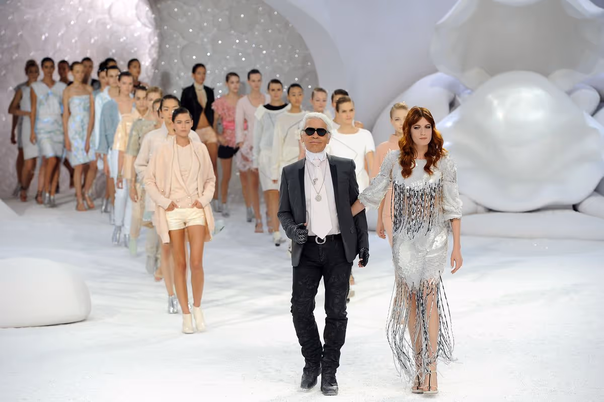 Karl Lagerfeld leads Florence Welch after the Chanel spring 2012 show.