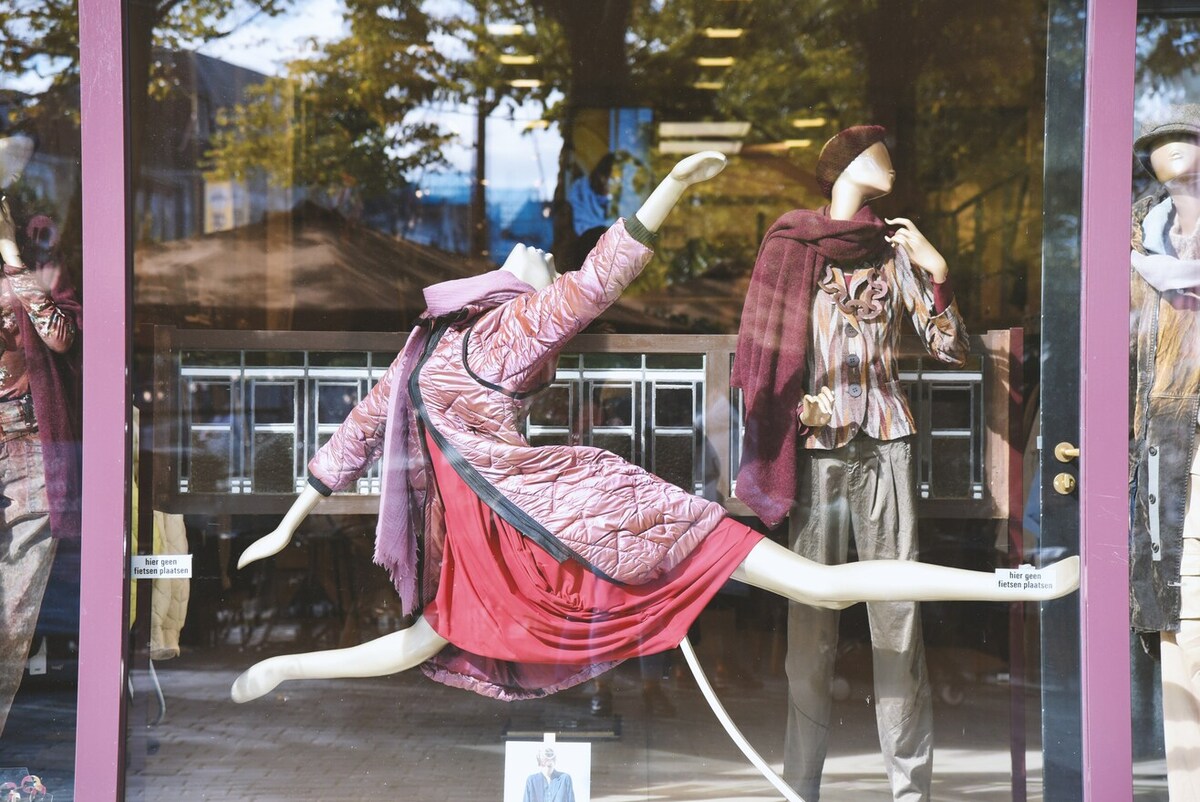 A mannequin dressed in pink, in a dramatic pose.