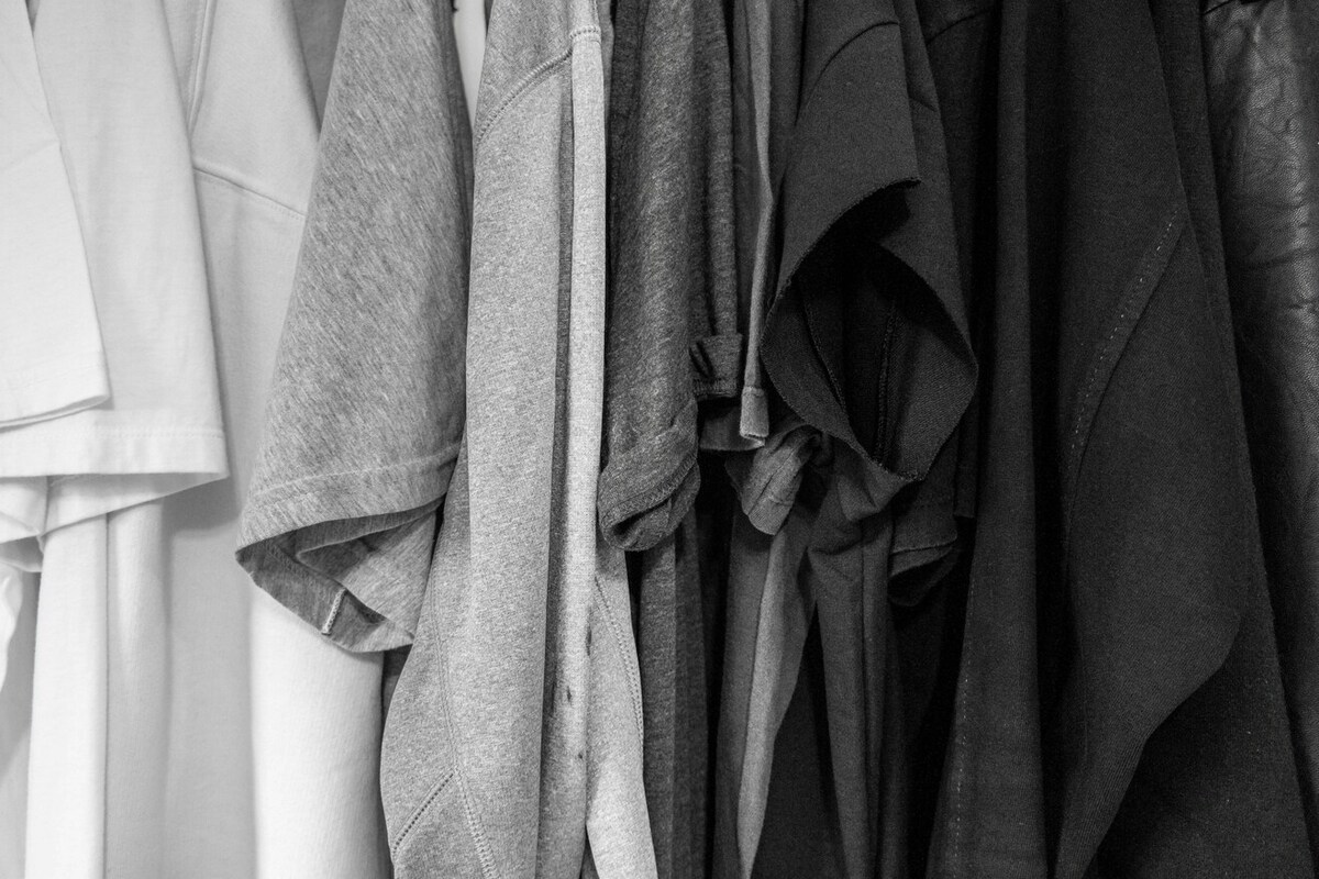 A greyscale image of t-shirts lined up.