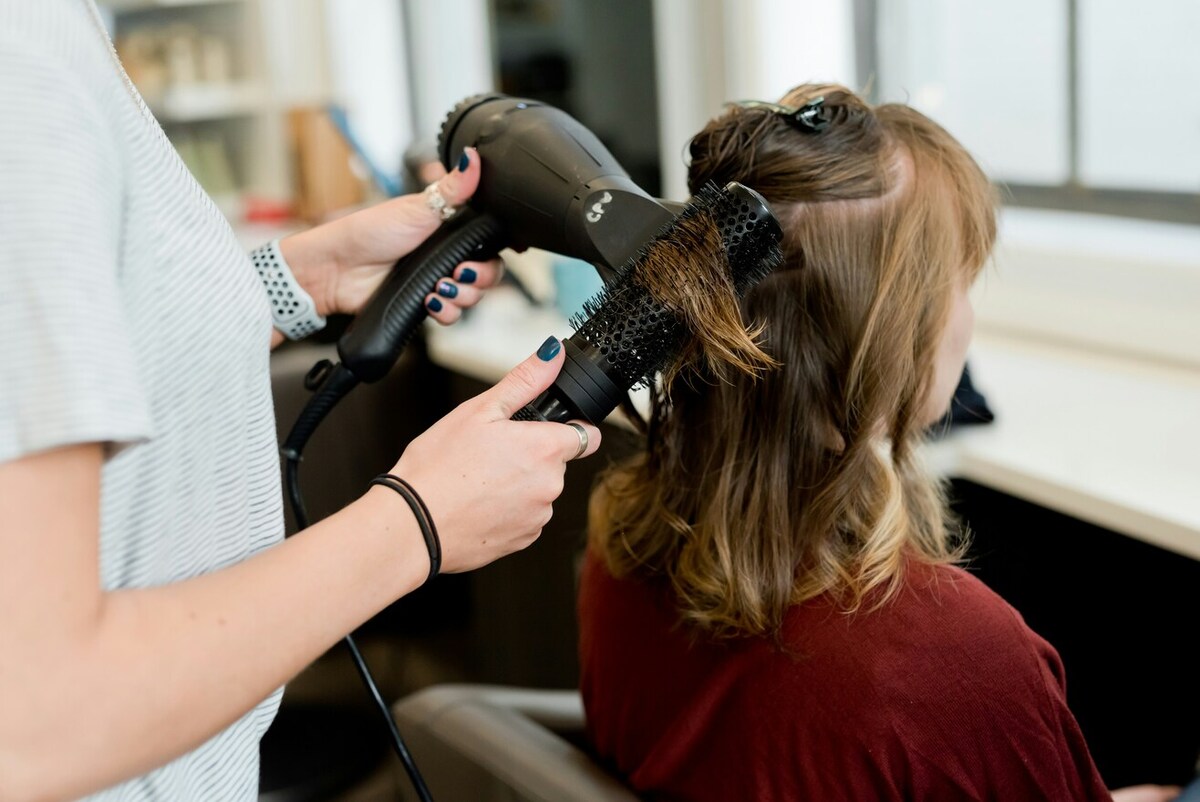 An image of a person getting their hair styled.