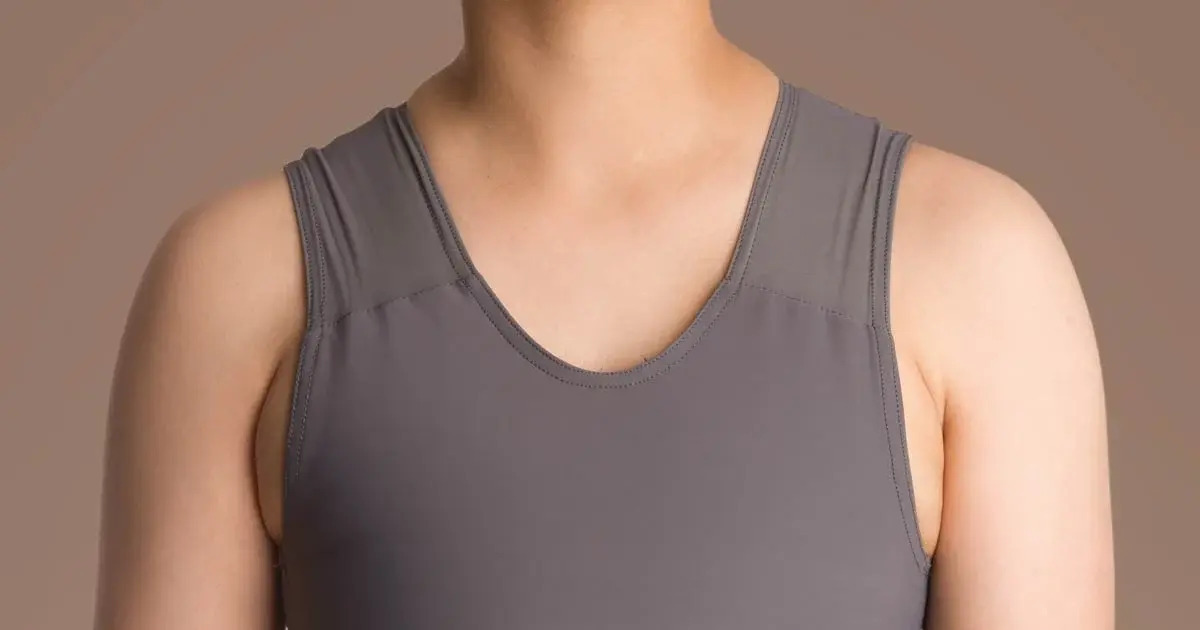 A person wearing a chest binder.