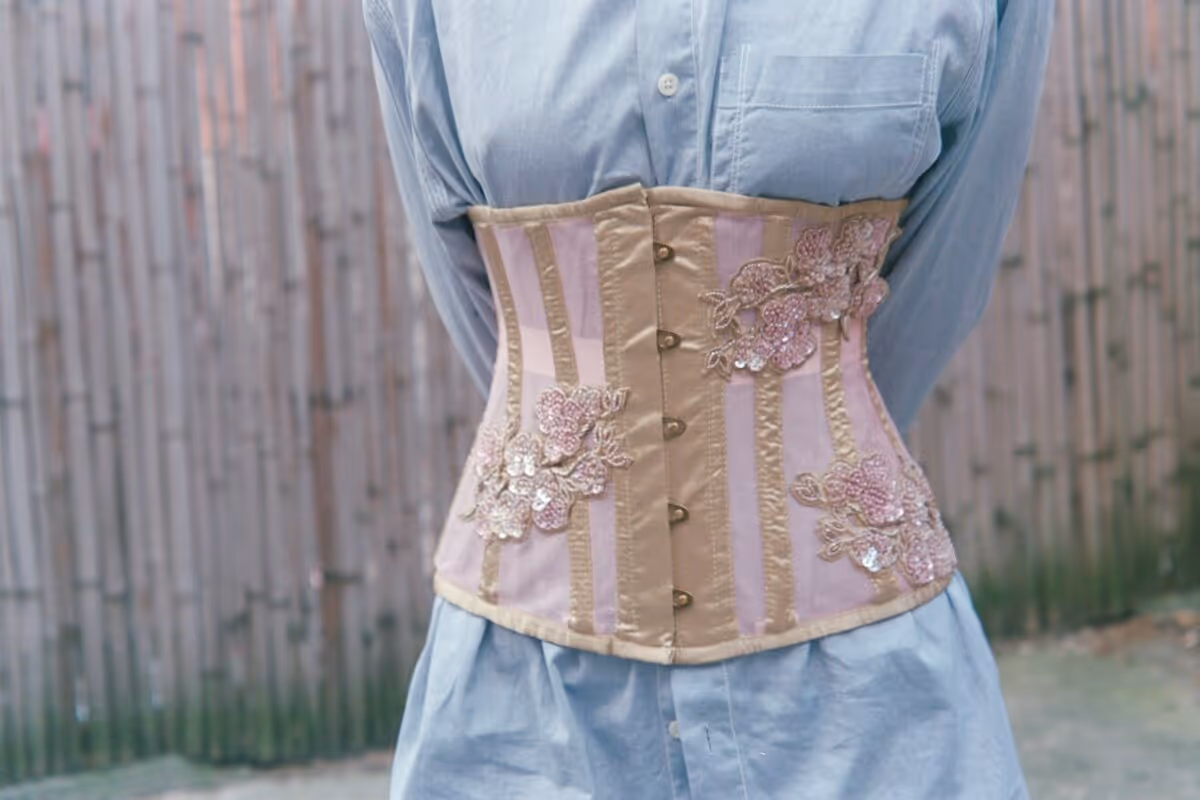 An image of a person wearing a modern pink corset.