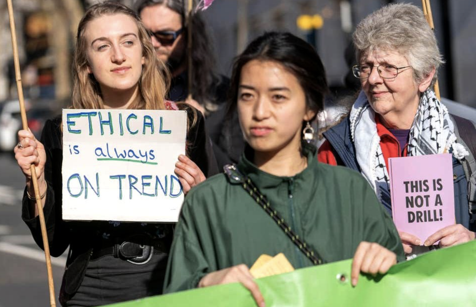 sustainable fashion protester holding a sign that says Ethical is ALWAYS on trend!