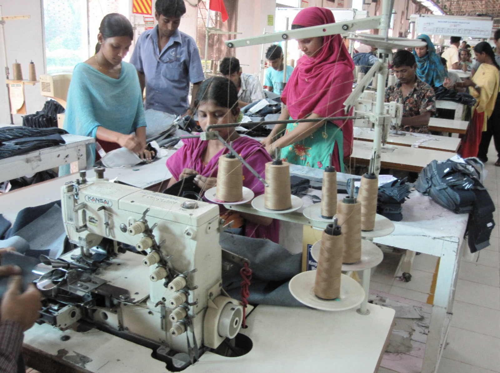 workers enduring unsafe conditions in a textile plant that does not use sustainable practices