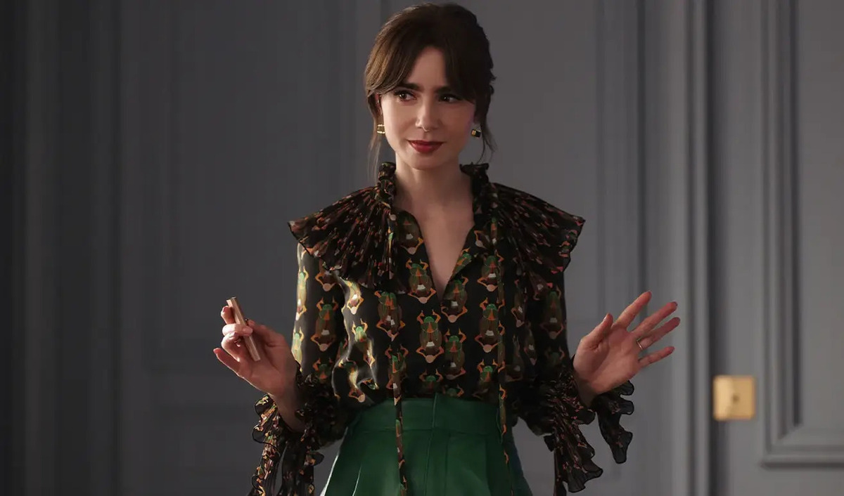 “Emily in Paris” protagonist Emily Cooper in a blouse with beetles printed on it.