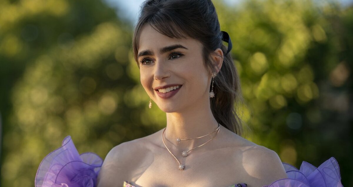“Emily in Paris” protagonist Emily Cooper in a sleeveless purple dress.