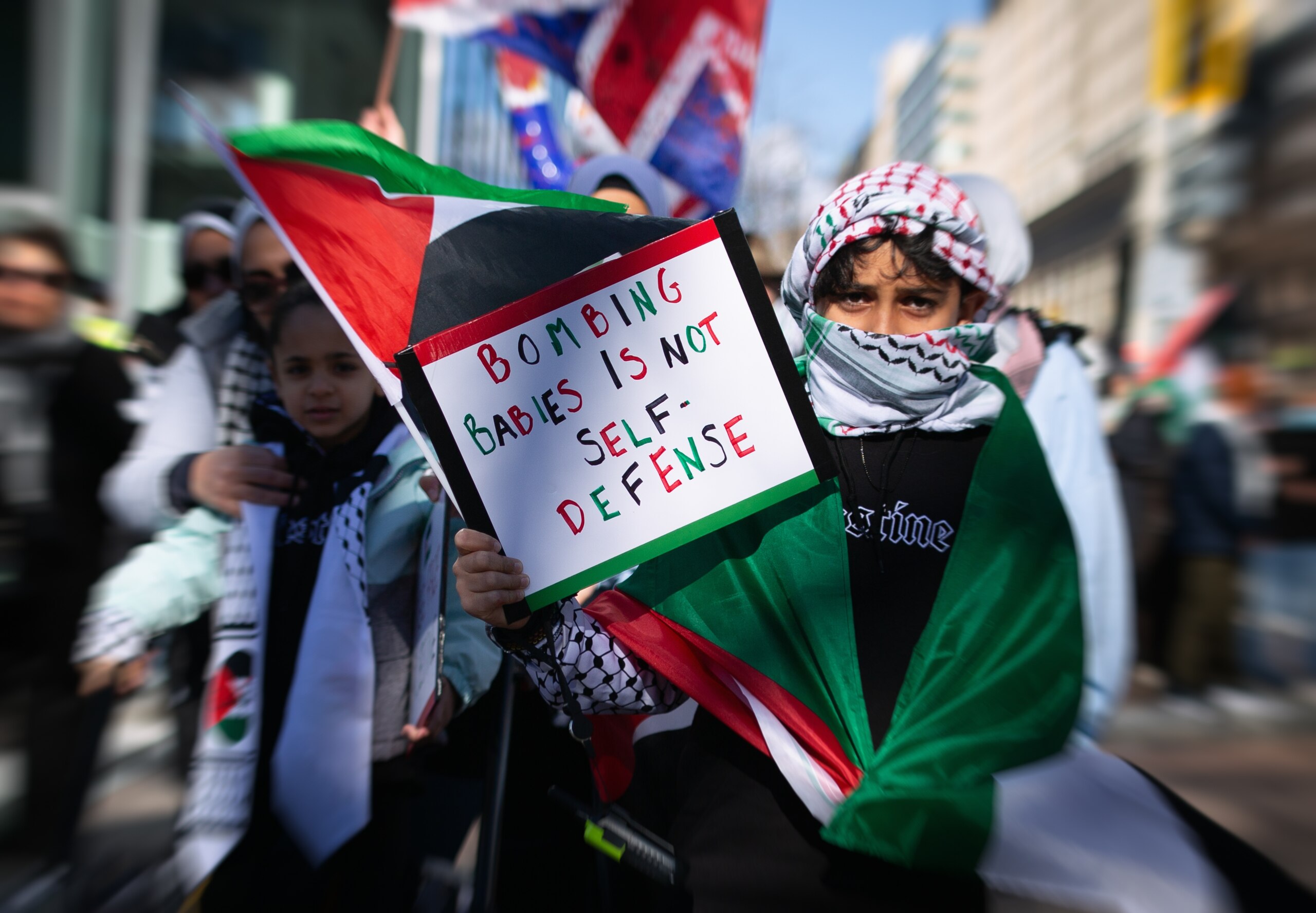 protester at the March for Gaza wearing a Keffiyah