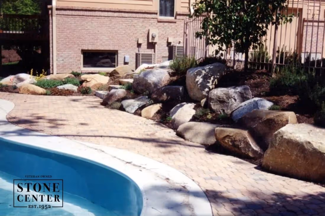 swimming pool surrounded by natural stone and boulders