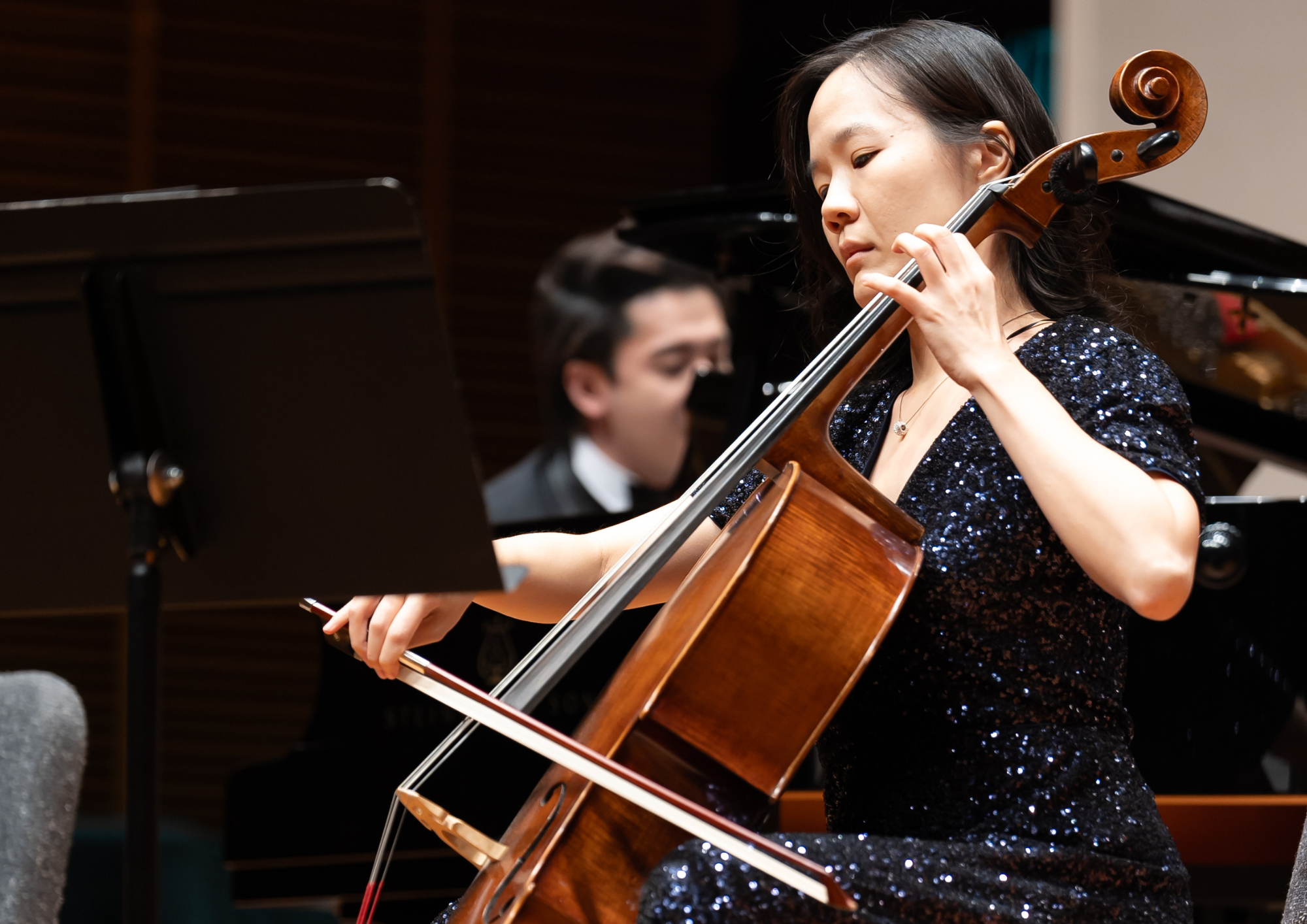 An adult playing the cello.