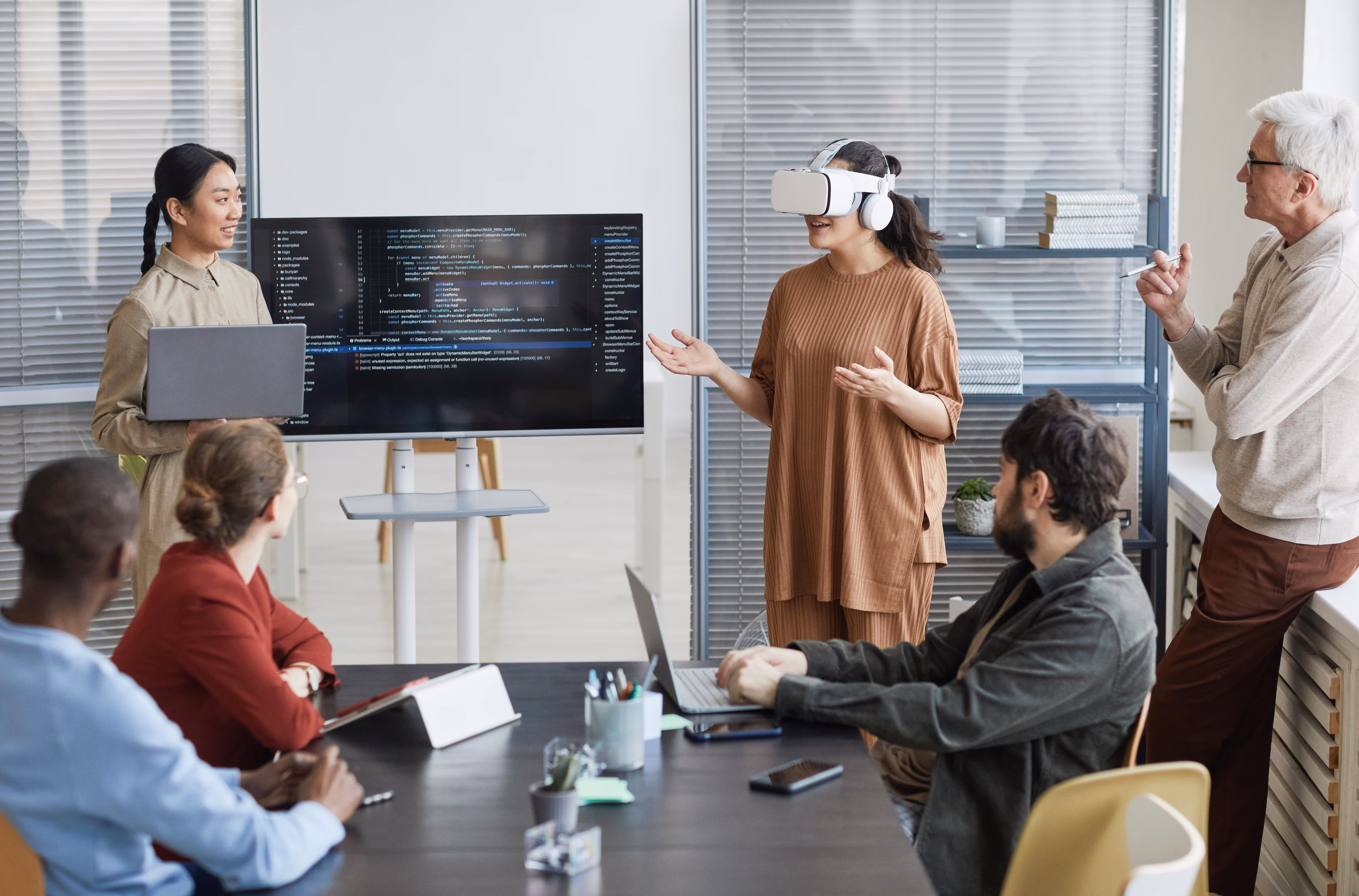 Business meeting with woman on VR headset giving feedback