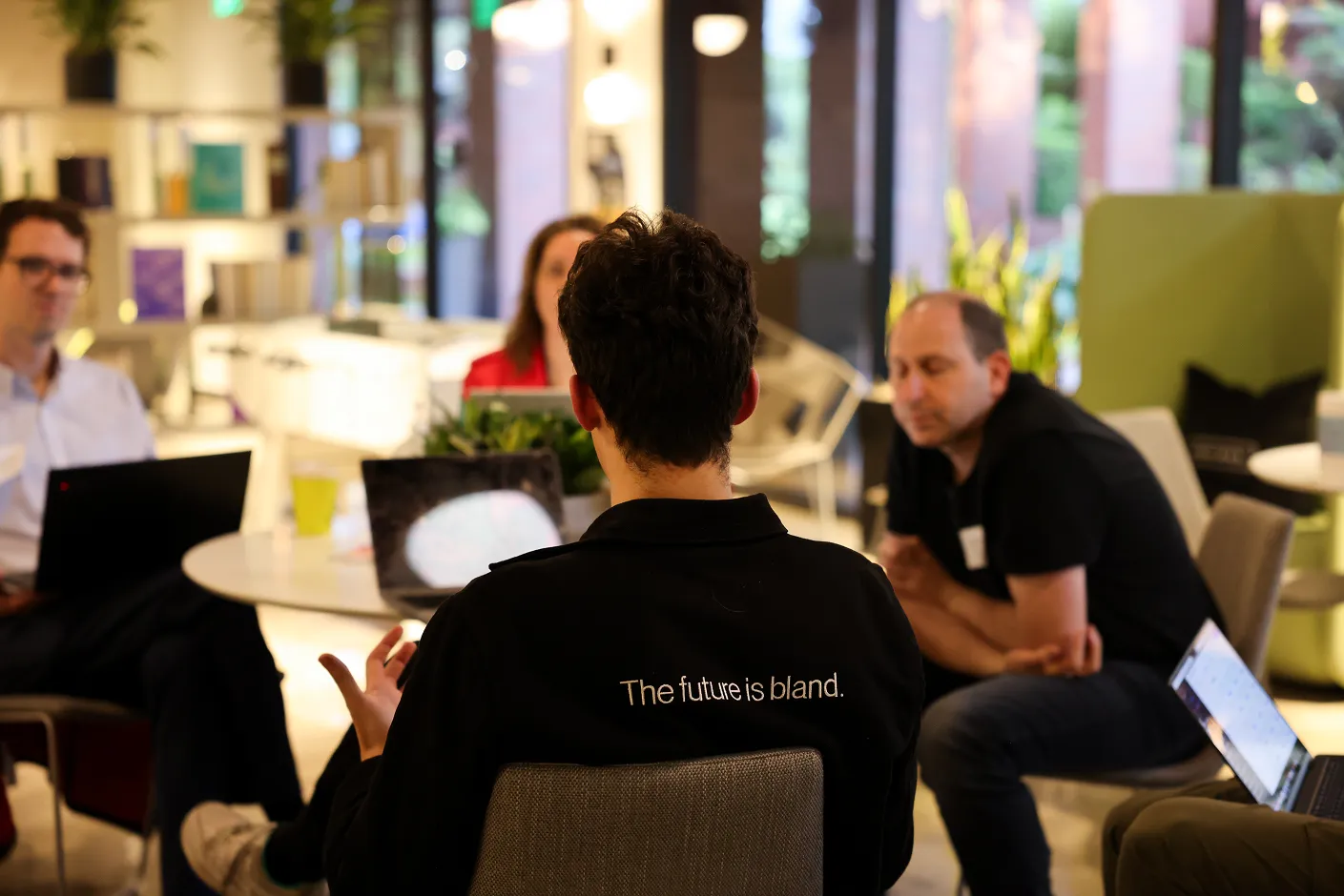 A man wearing a black shirt with the words "The Future is Blind" on it.
