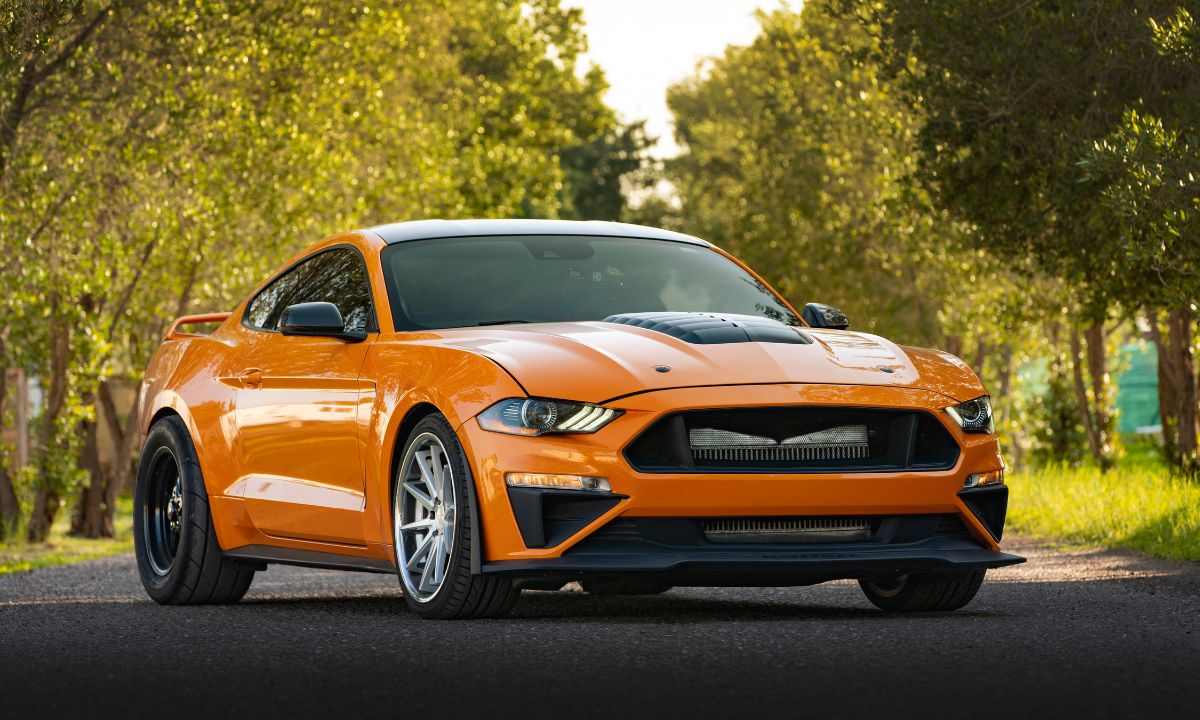 Orange sports car parked on a tree-lined suburban street, pedestrian safety ratings for cars
