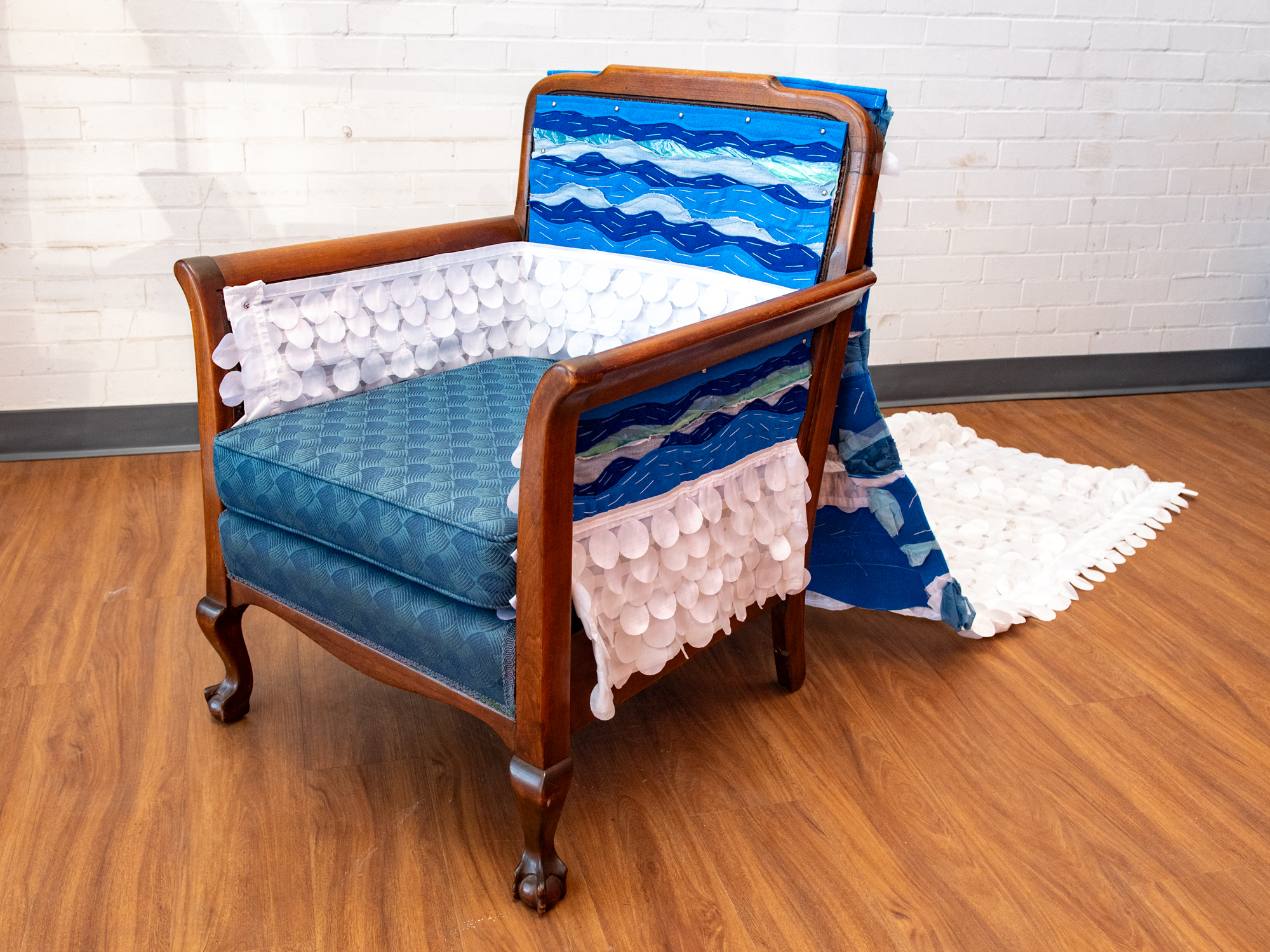 “Tidal Throne” Repurposed polyester, post-consumer plastics, and embroidery thread, and vintage chair, 33" x 24" x 26" with a 72" removable train