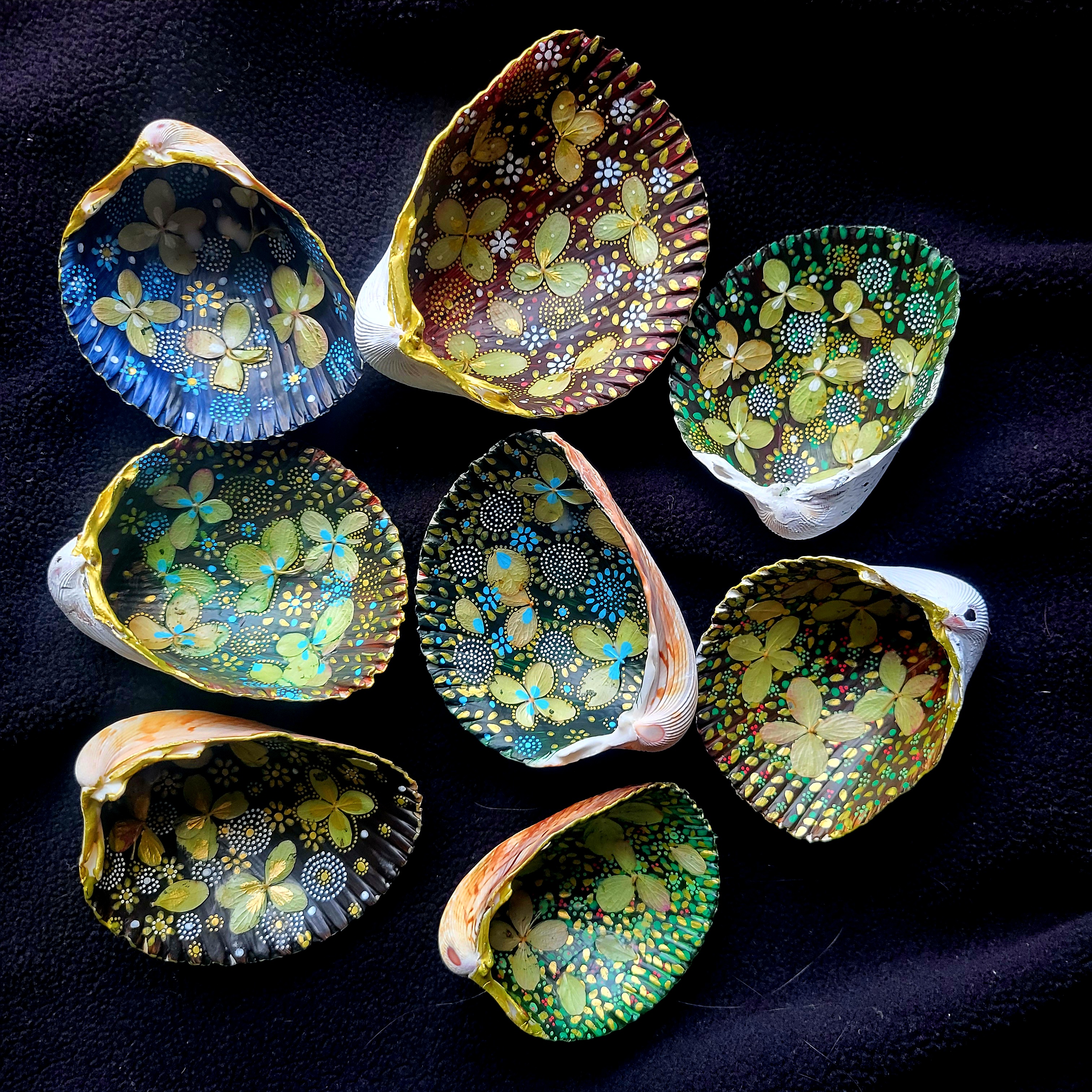 “Cockle shells all in a row” 2025, Cockle shells, hydrangea florets and paint pens, 3” x 4” x 2”