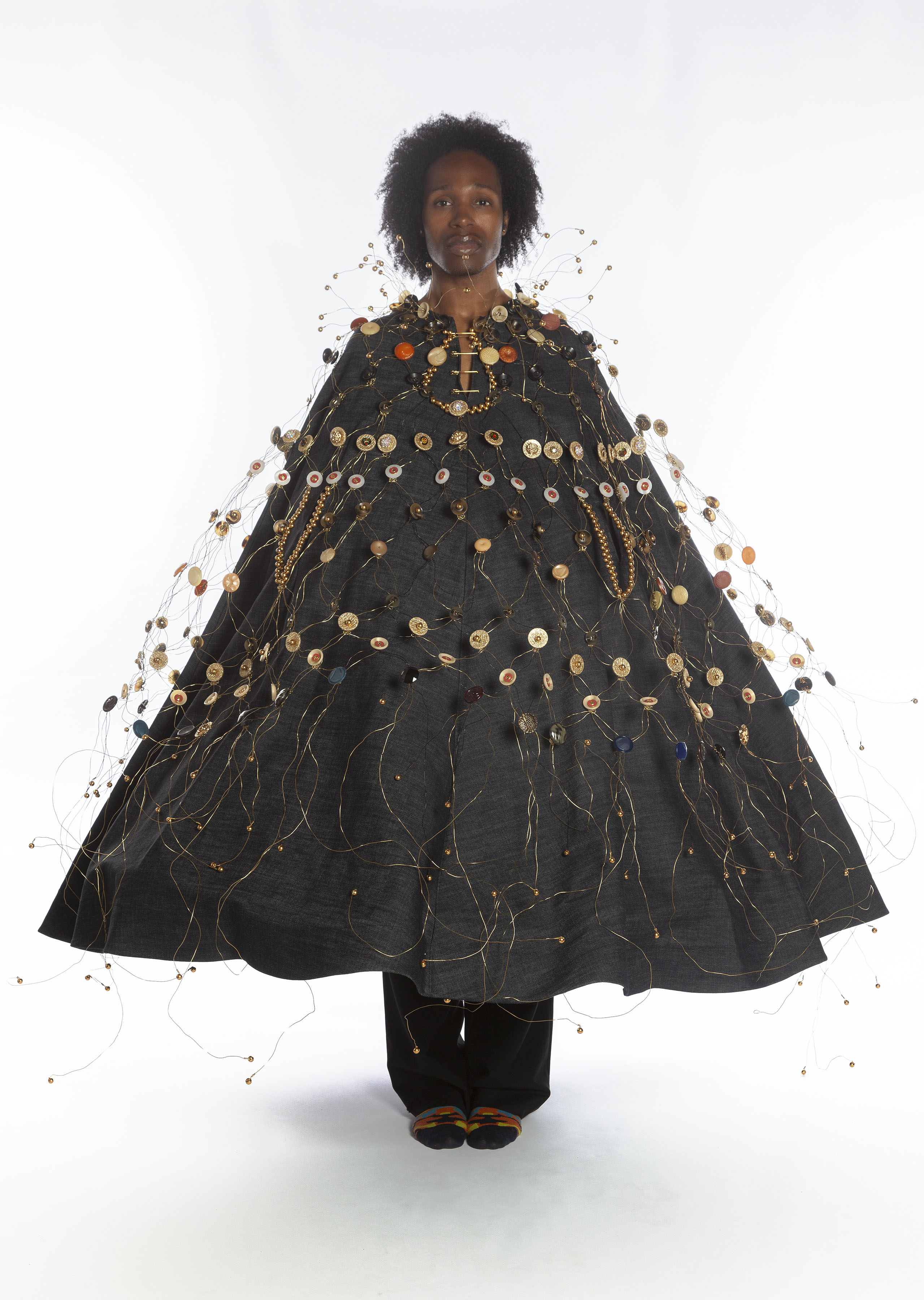 Button Armor Ensemble, 2023, wearable art, armor: metal and plastic clothing buttons, wire; denim caftan: designed by Beau McCall with garment production by Strugala; hoop skirt, dimensions variable.