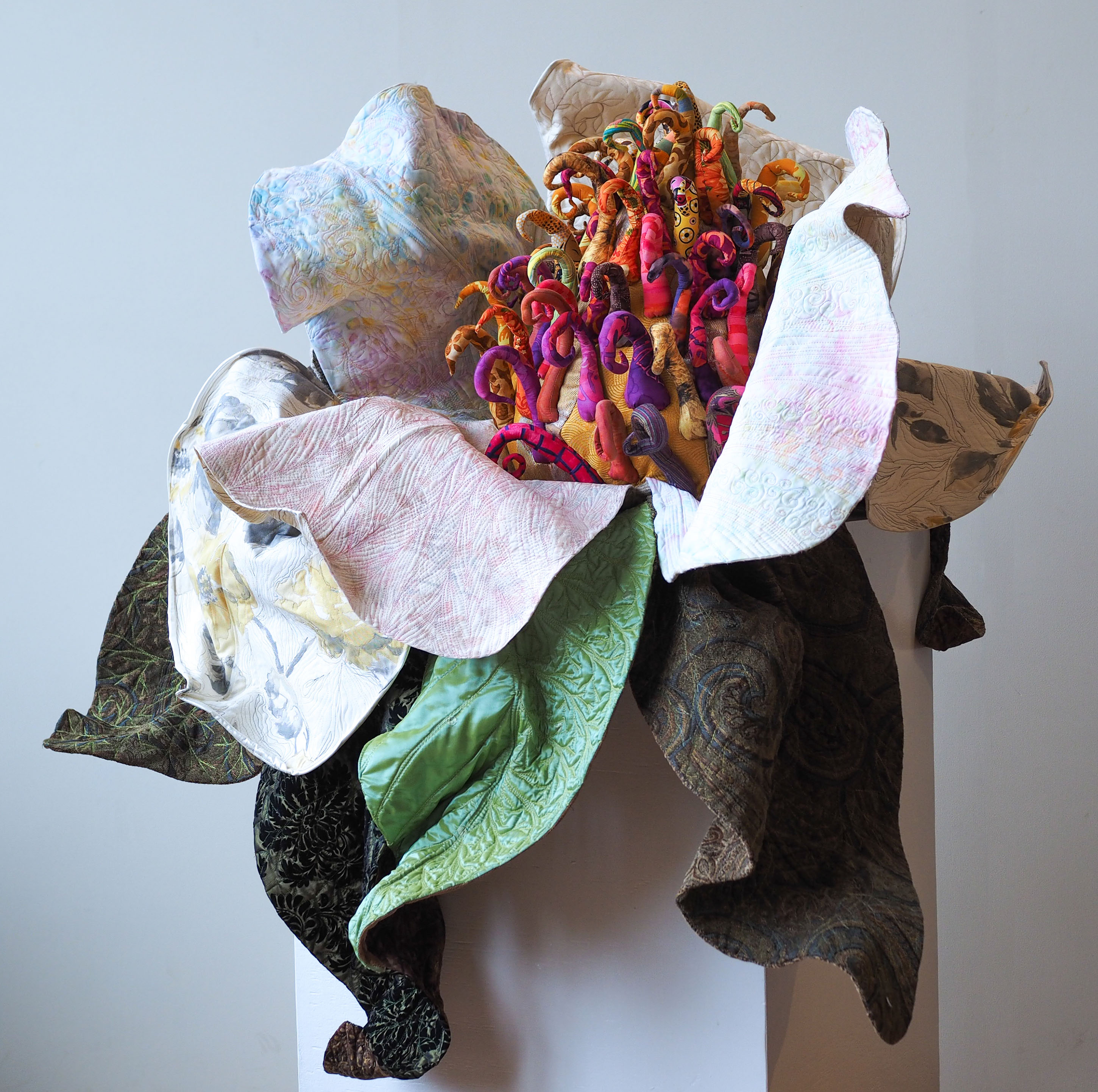 “Magnolia Grandiflora III: Resurrected” 2023, Machine quilted, machine raw edge appliqued, machine thread painted, hand & machine constructed. Cotton, vinyl, reclaimed & other textiles, thread, cotton batting, polyester stuffing, wire. 32" h x 48" w