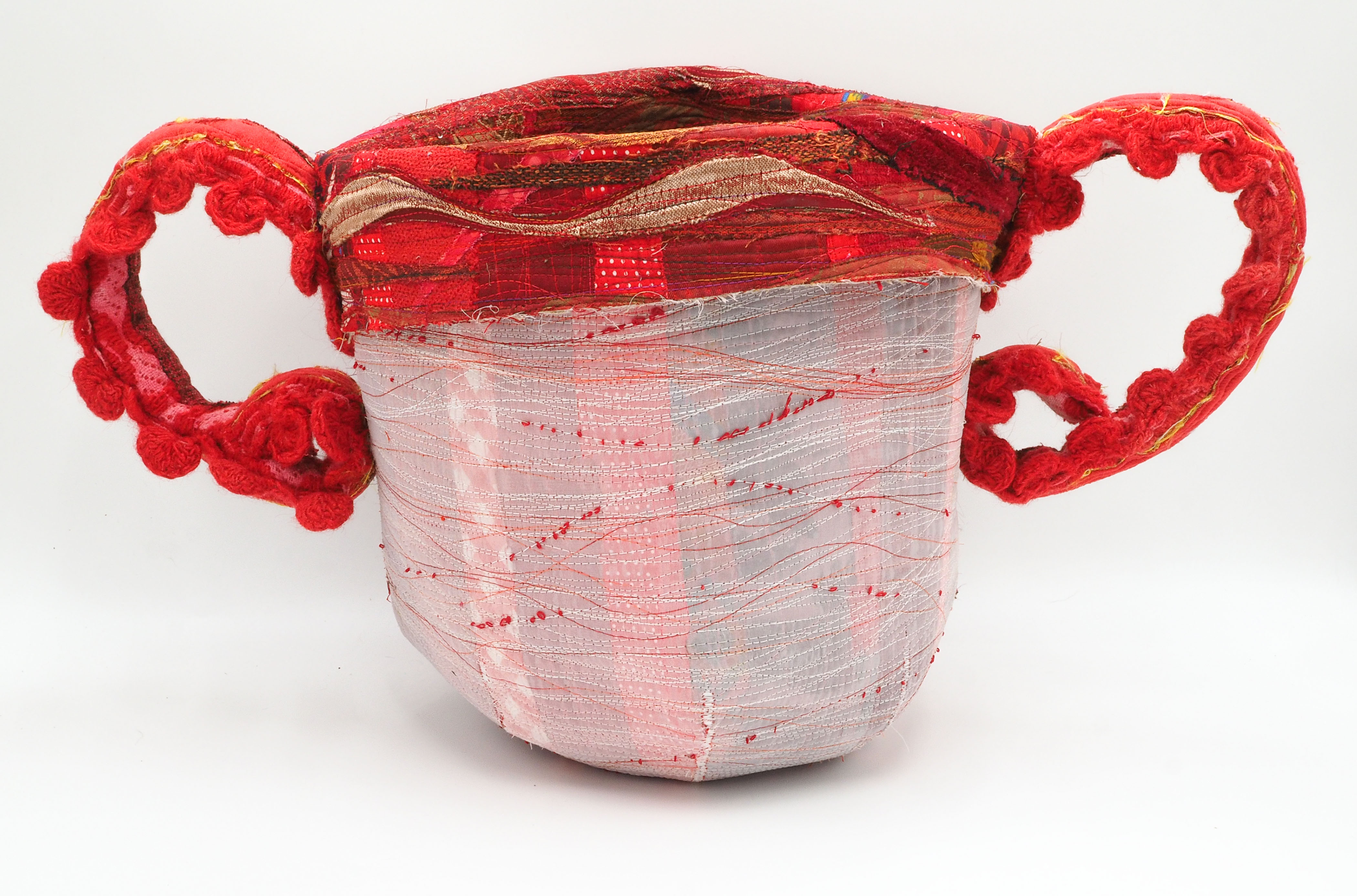 “Whitewashed series: Mine?” 2025, Machine quilted, machine thread painted, machine raw edge applique, hand & machine constructed. Reclaimed wool tablecloth, decorator samples and other textiles, cotton batting, thread, wire. 12 ½” h x 23” w x 10 ½” d