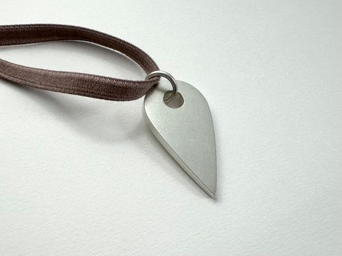 You Are Here Necklace, 2024 | Sterling silver hollow form, Japanese rayon velvet; 2 x 1 x ⅛ inches, variable length