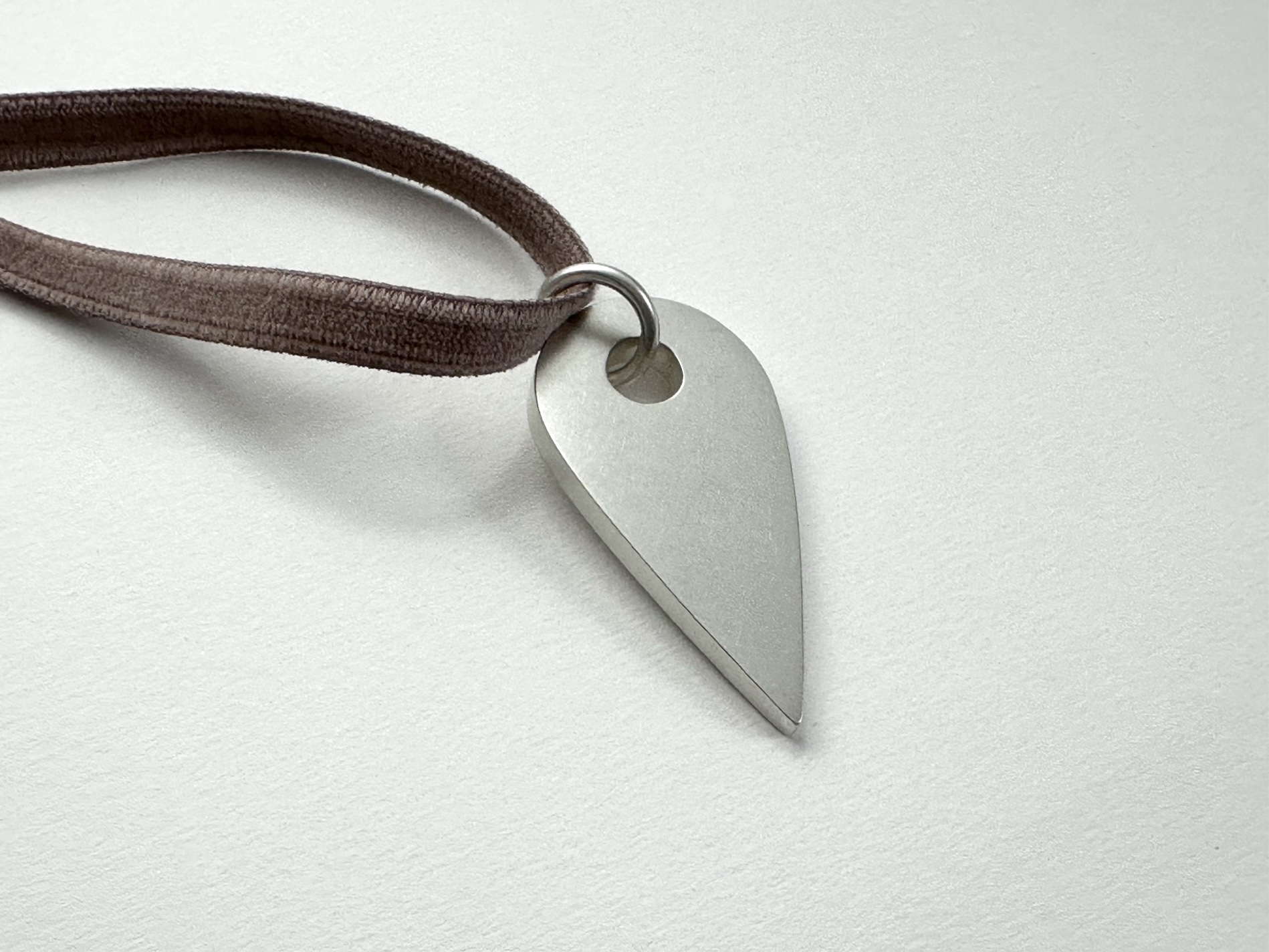 You Are Here Necklace, 2024 | Sterling silver hollow form, Japanese rayon velvet; 2 x 1  x  ⅛ inches, variable length