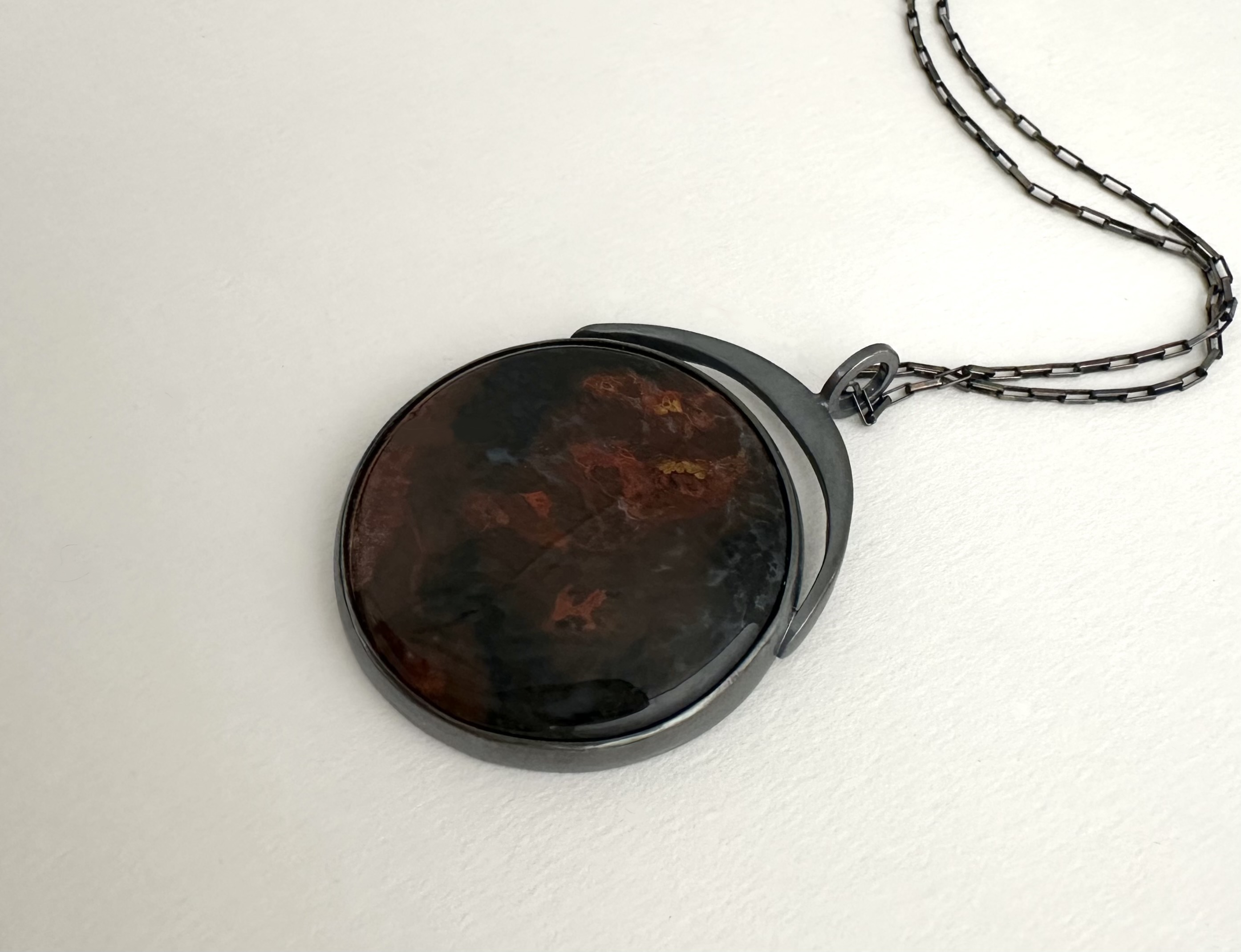 Red Moon Necklace, 2025 | Oxidized sterling silver, red agate; pendant is 1 ⅞ x 1 ⅜ inches, 30 inch oxidized sterling silver elongated box chain