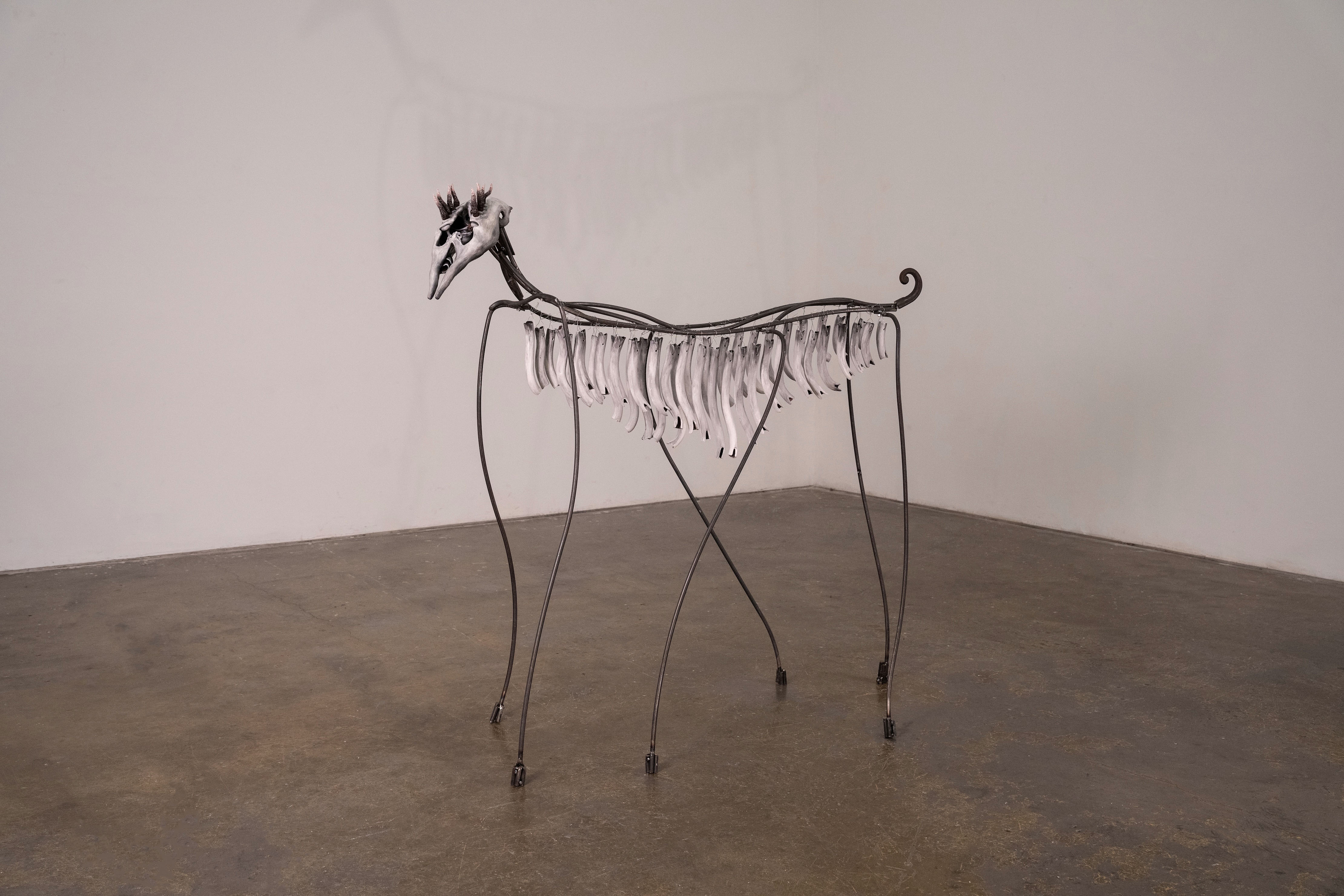 Chimes Horse, 2026, ceramic, underglaze, steel, wool, sound, 63” x 65” x 18" The chimes are a reference to the earliest discovered instrument, the Divje Babe flute, found in Slovenia and dates back 50,000 to 60,000 years.