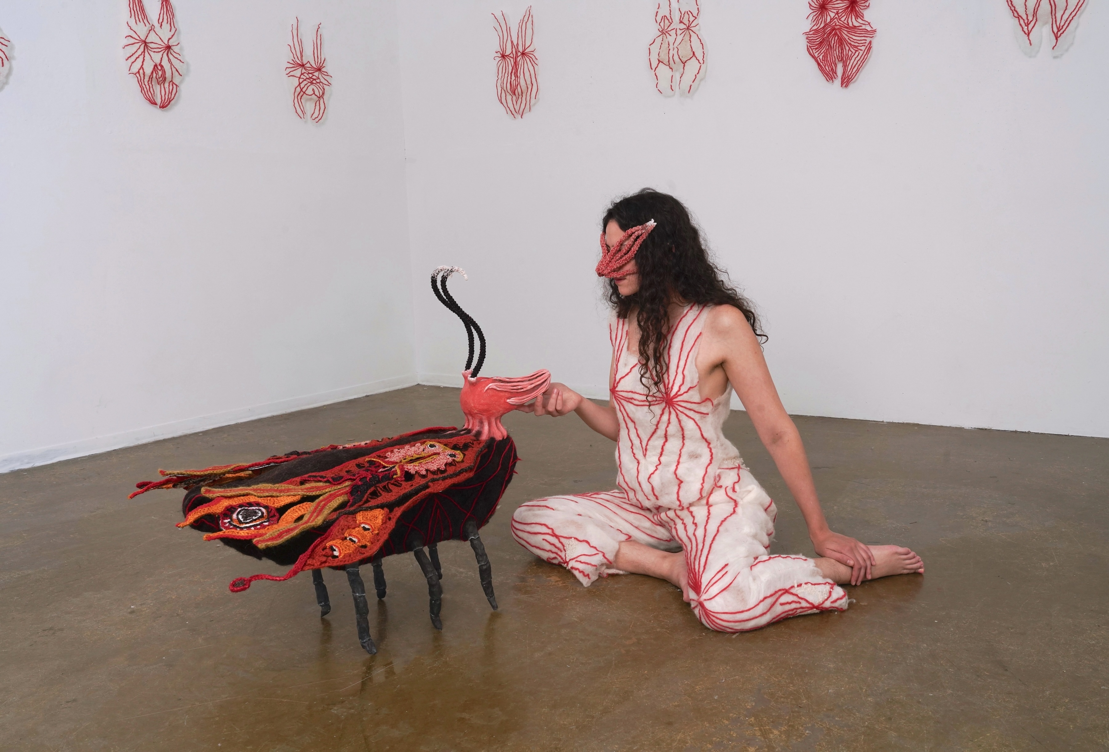 Eco/Femme/Death/Fairy, 2024, Ceramics, wool, wood, wire, 30” x 29” x 32” Image still from performance with chthonic creature on the heartbreak of domination, on mustering courage.