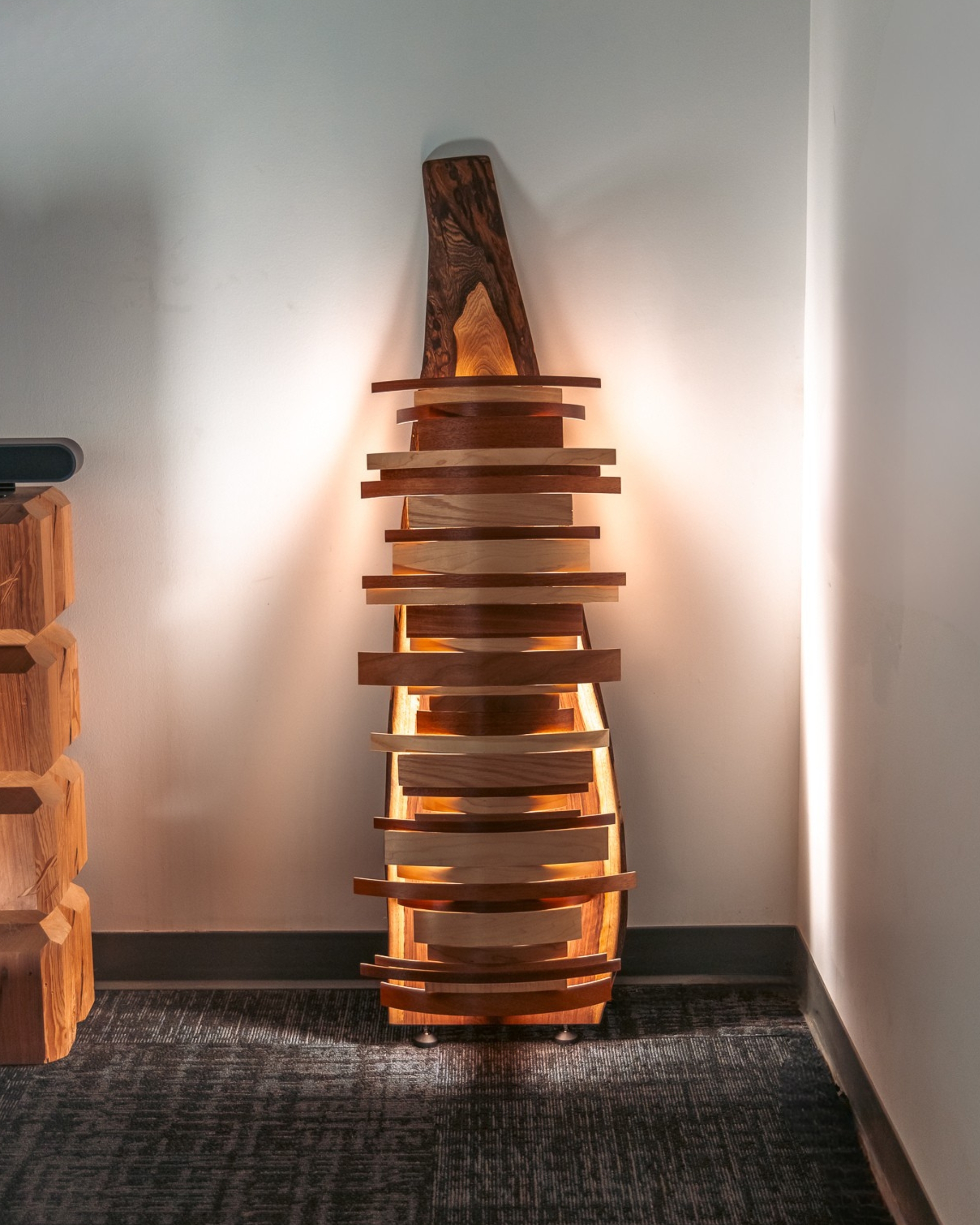 "Totem One" 2026, walnut slab, wood drum shell fragments, LED fixture, 54” x 20”