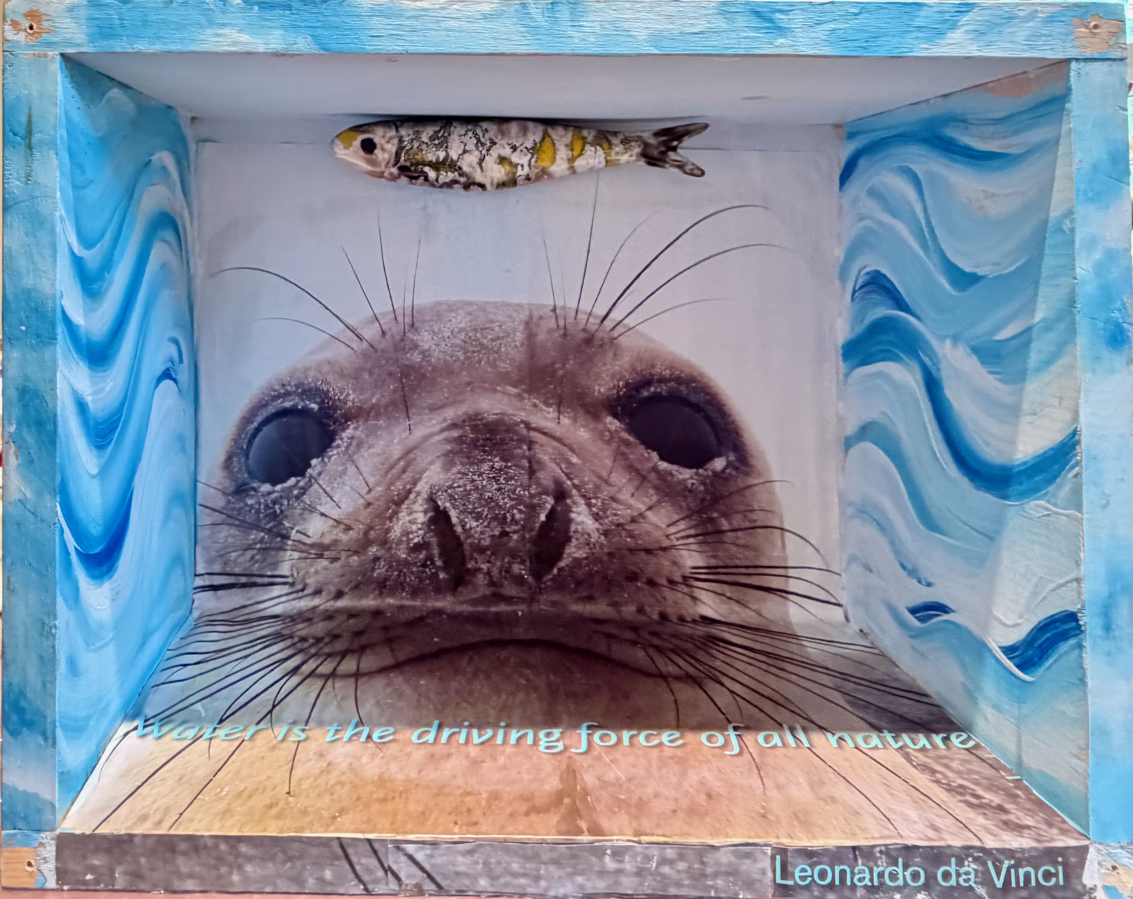 "Water is the Driving Force of All Nature" acrylic paint, ceramic fish, paper, wooden box, 12" × 15" × 7"