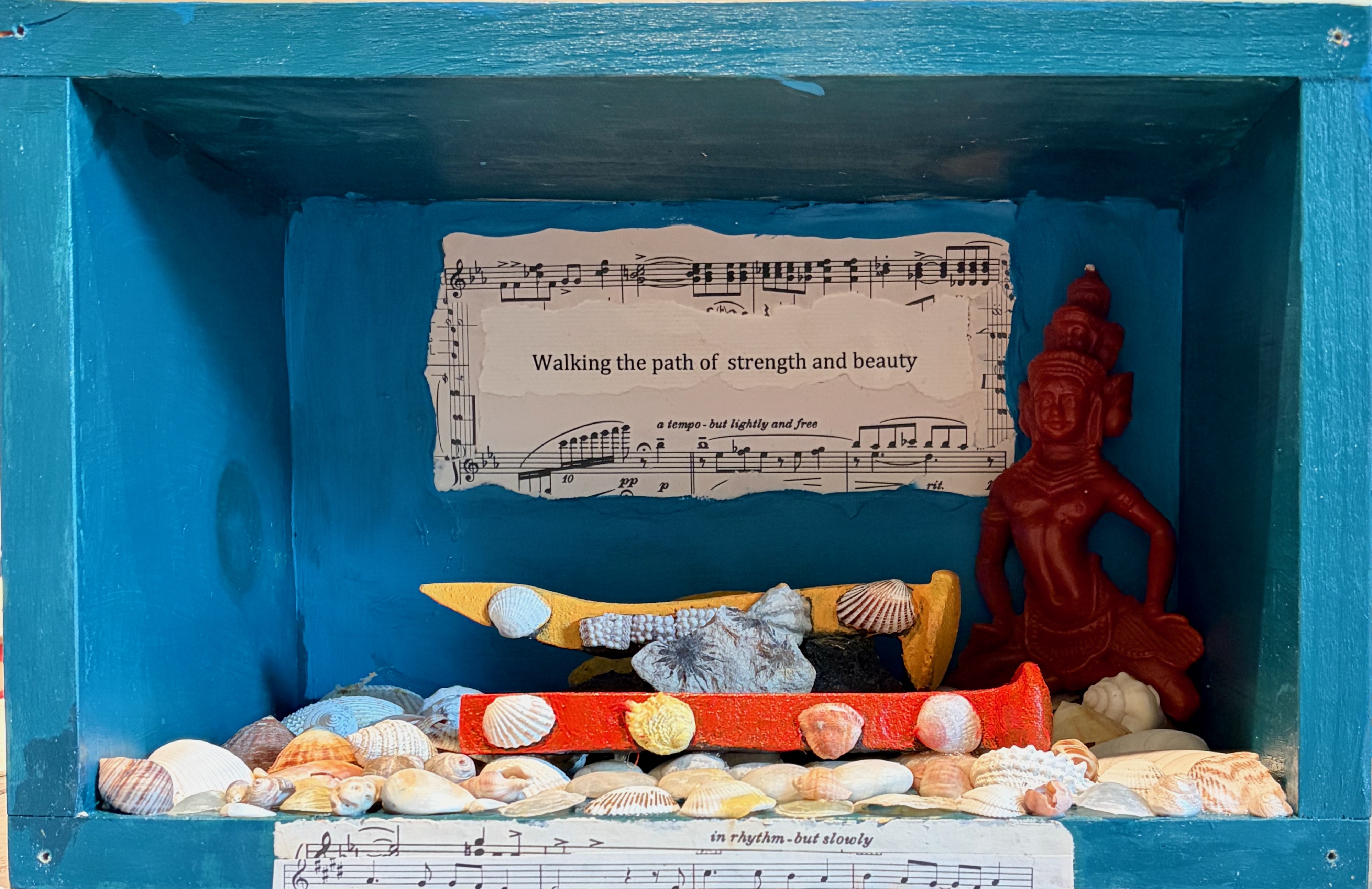 "Walking the Path of Strength and Beauty" railroad pins, shells, Tara candle, sheet music, acrylic paint, wooden box, 9" × 13" × 7"