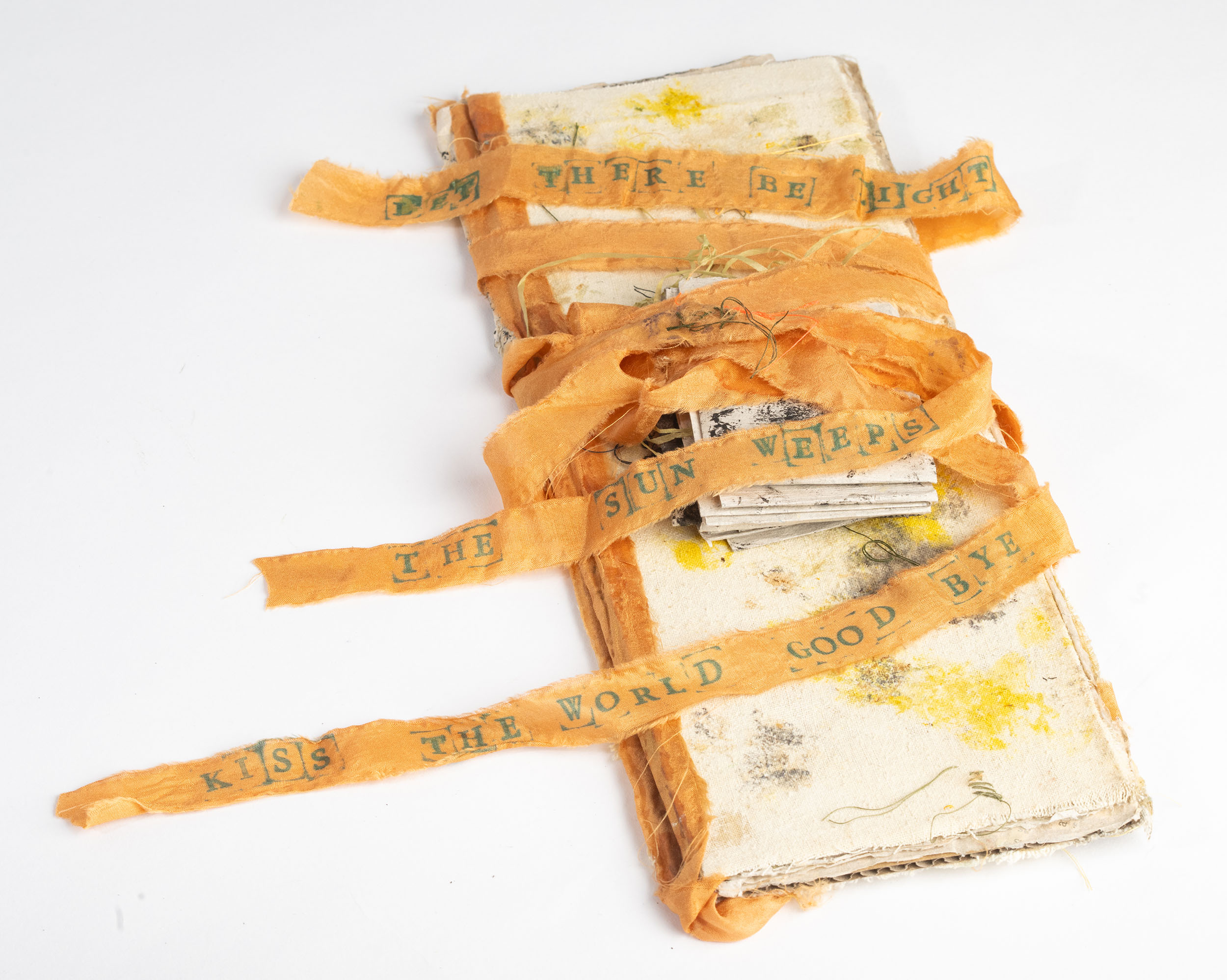 "Homage to Anselm Keifer: Sunflower #2" 2026, Ecoprint, naturally dyed silk ribbon and papers, 11" l x 4" w x 1" d