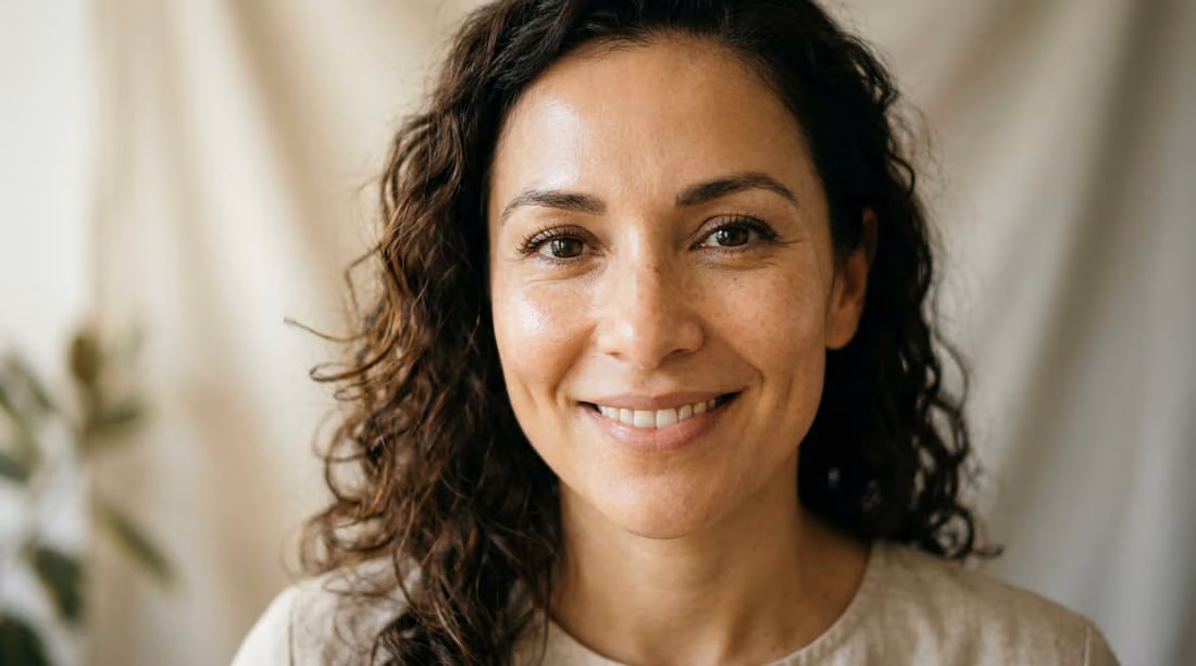  A close-up portrait of a woman with naturally lifted, well-defined cheekbones and healthy skin