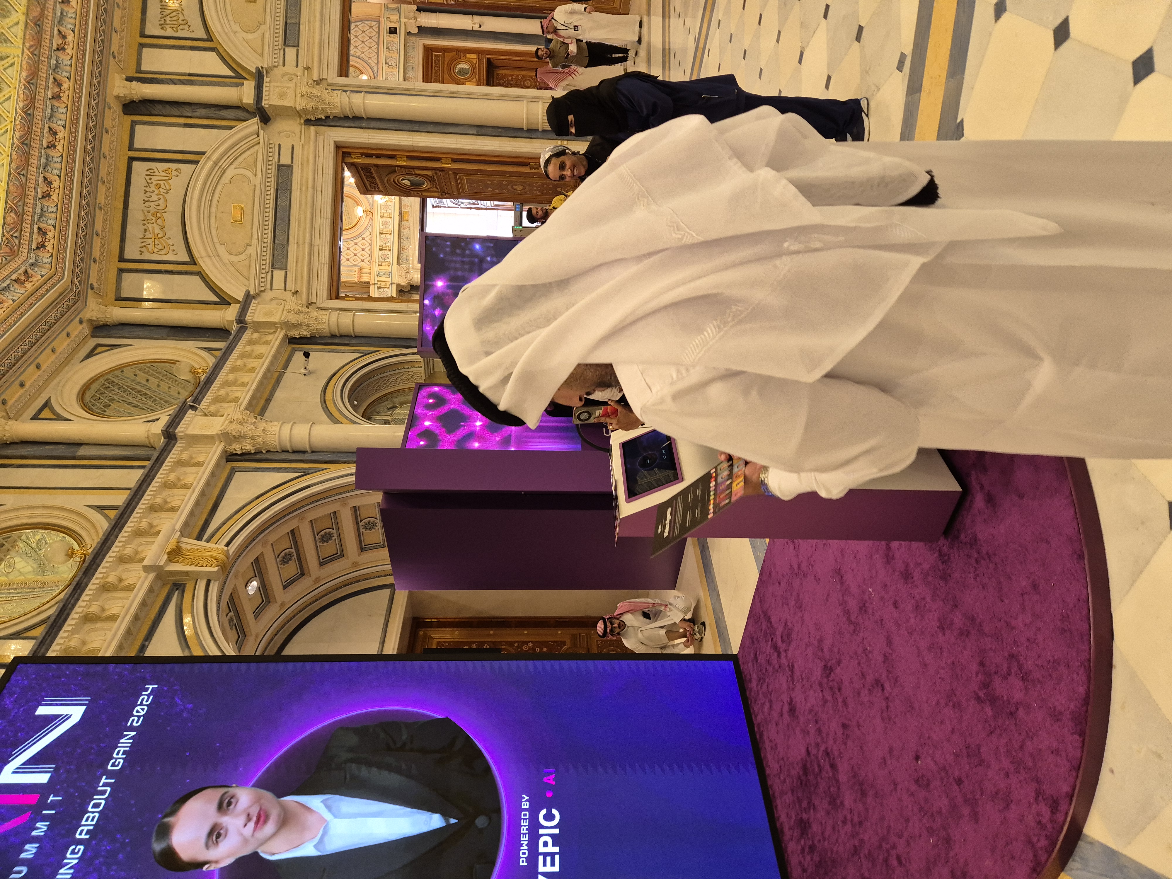 A summit delegate speaking to Yepic’s giant real-time AI avatar