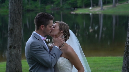 Bride and Groom Kiss by lake