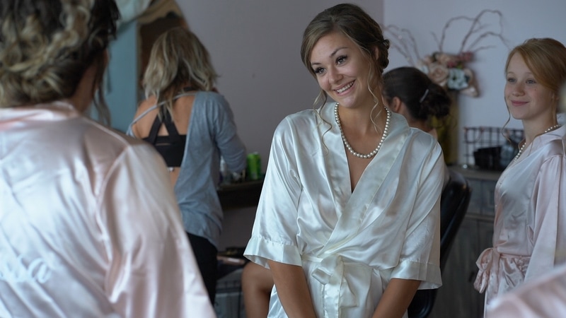 Bride smiling at mother in dressing room