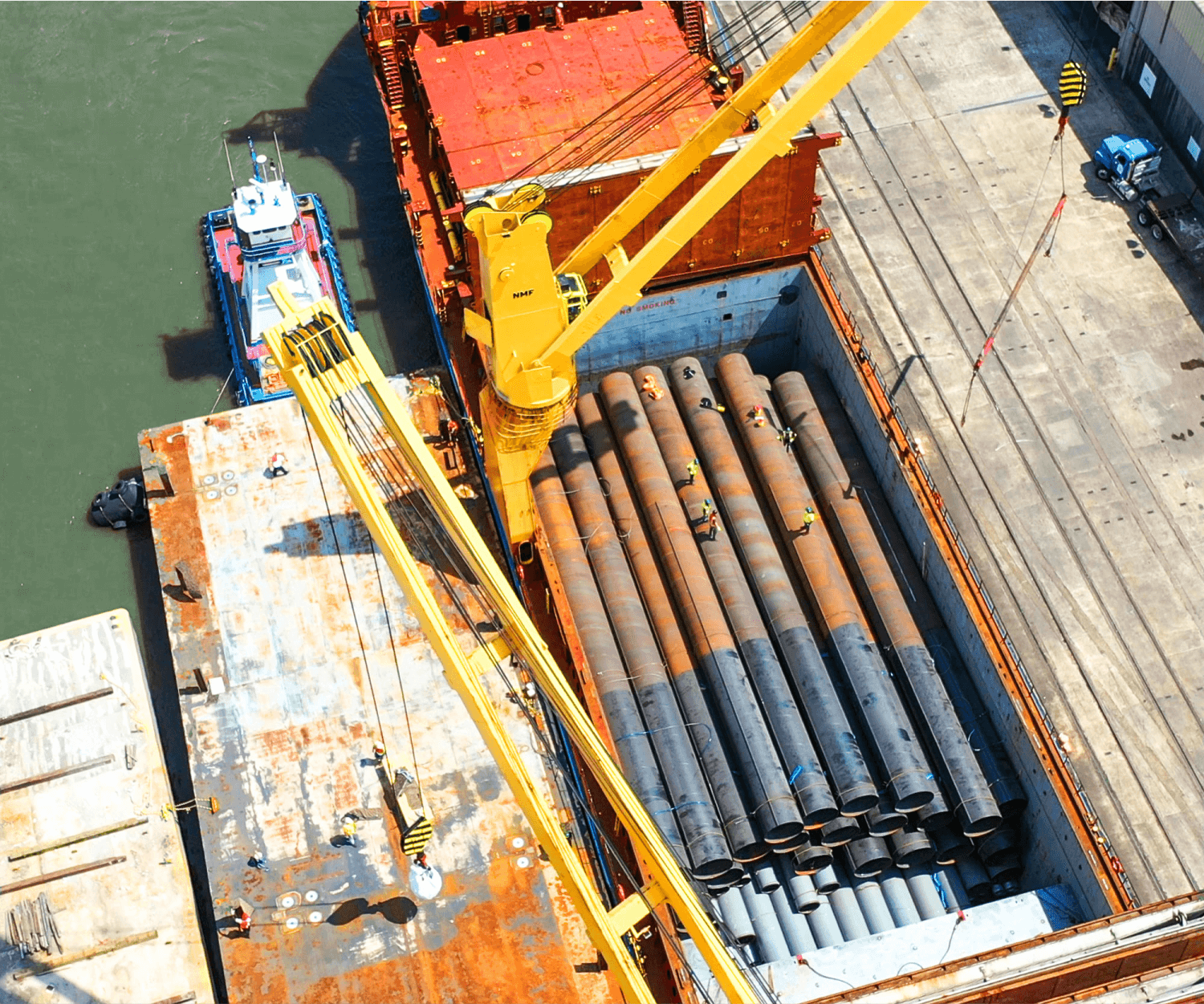 This image shows a load of pipe being handled at the Port of Houston and demonstrates 6Gen's industry of shipping steel logistics.