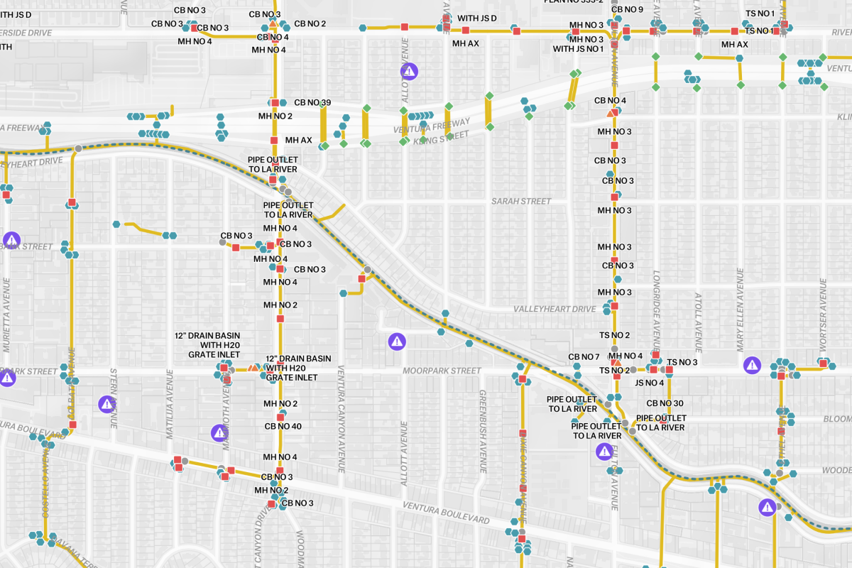 A technical GIS utility map of an urban drainage system, showing a network of color-coded pipes, outlets to the LA River, and specific maintenance points for infrastructure management.