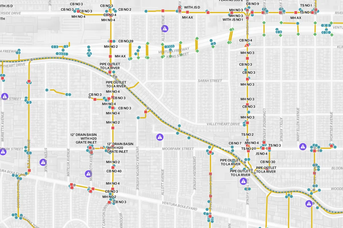 A technical GIS utility map of an urban drainage system, showing a network of color-coded pipes, outlets to the LA River, and specific maintenance points for infrastructure management.