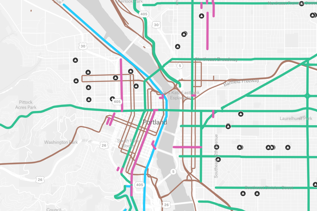 A simplified transit and road network map of Portland, Oregon, showing color-coded routes and infrastructure markers across the city's grid and Willamette River crossings to assist in urban mobility planning.
