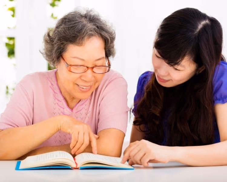 adult child reading with mom