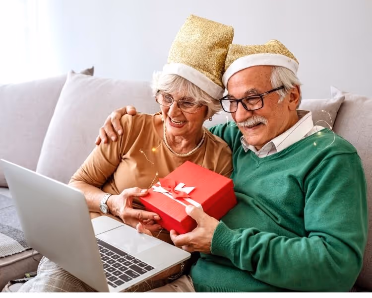 A senior couple on a video call at Christmas time